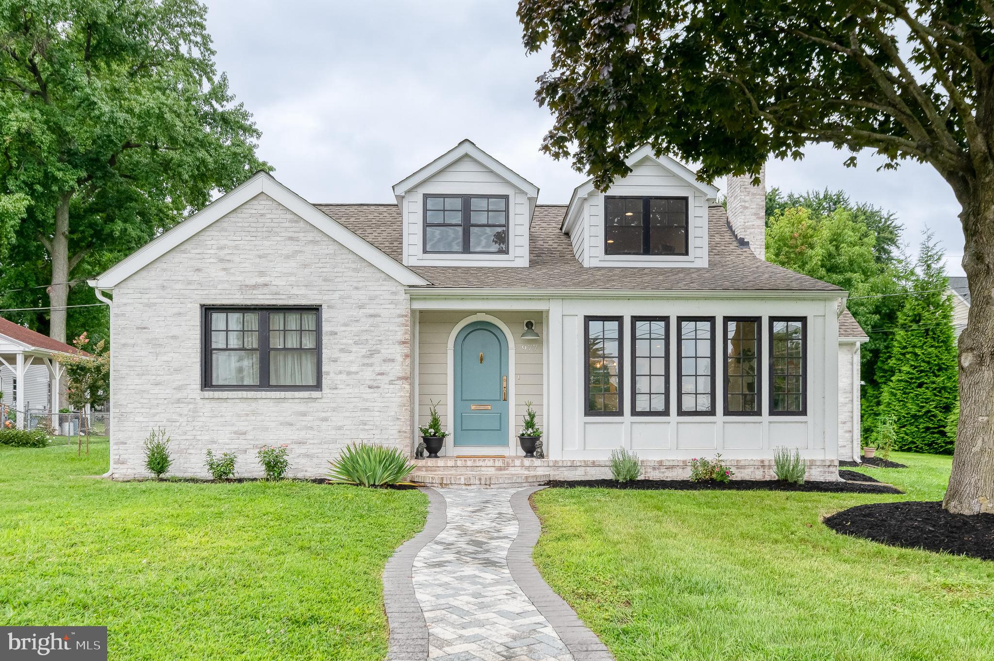 Exceptional, fully renovated home with stunning Chesapeake Bay views! Completely remodeled from top to bottom in 2023, this thoughtfully designed home blends timeless charm with modern luxury. Step through the elegant arched front door into an open-concept layout featuring hardwood floors throughout and a custom staircase. The gourmet kitchen boasts soapstone countertops, high-end appliances—including an induction range—and beautiful cabinetry. Enjoy serene water views from the sun-drenched, well-appointed sunroom.
The back entrance leads to a functional mudroom with laundry and a convenient half bath. Energy efficiency is key with a state-of-the-art geothermal heating and cooling system and an electric car charger already installed. Upstairs, the inviting loft offers endless possibilities—home office, guest space, or cozy retreat. Every detail has been carefully curated to offer both comfort and sophistication.