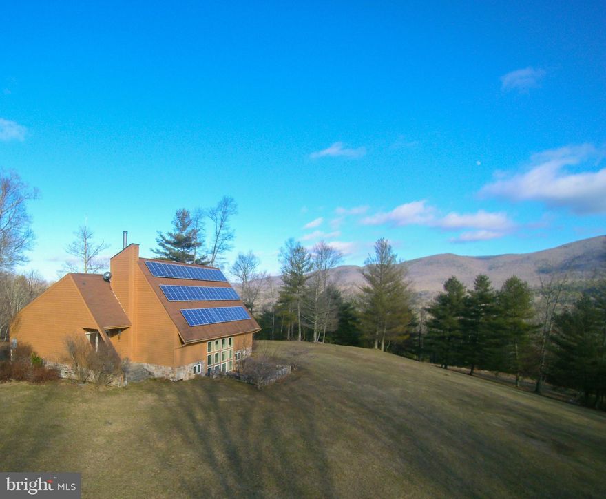 This is truly a one of a kind property.  There are 2 houses located on 106 acres of wooded private land that backs to the National Forest.   The main house features a main level open floor plan with the master bedroom that has a porch with mountain views.   The windows on the rear on the home let in plenty of natural light and are a well planned custom feature.  The lower level of the home features a kitchen, and 2 full bedrooms on either side of the rear windows.   A spacious 2 car garage with extra storage is accessed from the interior of the home as well.  The second house is a traditional design and is would be a fantastic rental property or au-pair suite.   There is also a 2400 square foot barn located on the property, as well as a 110 foot tower.   Also see  23597 Sam Snead Highway - for sale separately, located at the entrance of the driveway.