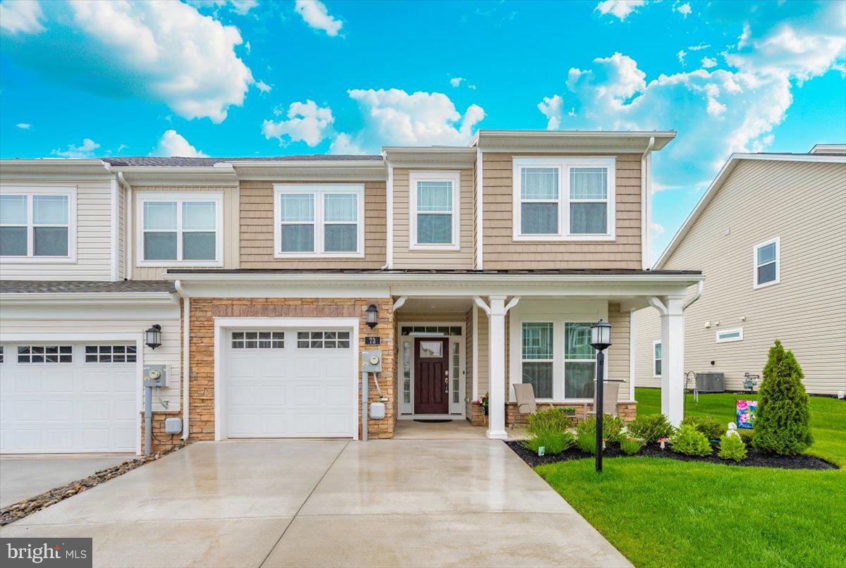 Welcome to 73 Boneset Drive, a stunning 2,739 square foot home nestled in the heart of the sought-after Amblebrook community in Gettysburg. Built in 2023, this expansive two-story property showcases thoughtful design and luxurious upgrades throughout. From the moment you arrive, the large covered front porch offers a warm and inviting entry—perfect for relaxing with a morning coffee or greeting neighbors. The main level opens with a bright sitting area and flows effortlessly into a spacious living room and chef’s kitchen featuring a massive granite island, stainless steel appliances, and beautifully upgraded cabinetry. Elegant custom plantation shutters enhance both style and privacy throughout the home. The main-level primary suite provides a peaceful retreat, complete with a large walk-in closet and a spa-like en-suite bathroom offering a tiled shower and dual vanities. A powder room, laundry area, and attached one-car garage add to the everyday convenience. Upstairs, a spacious loft creates a flexible second living area, flanked by two generously sized bedrooms and a full bathroom. An additional finished storage room upstairs provides versatility and could easily be converted into a fourth bedroom, sewing room, or recreation space. Step outside to enjoy the beautiful screened-in porch overlooking a fully fenced backyard, which now includes a stunning custom stone patio—perfect for outdoor entertaining or quiet evenings at home. Located within the vibrant 55+ Amblebrook community, this home blends upscale living with a resort-style atmosphere, offering the perfect combination of space, comfort, and serenity.