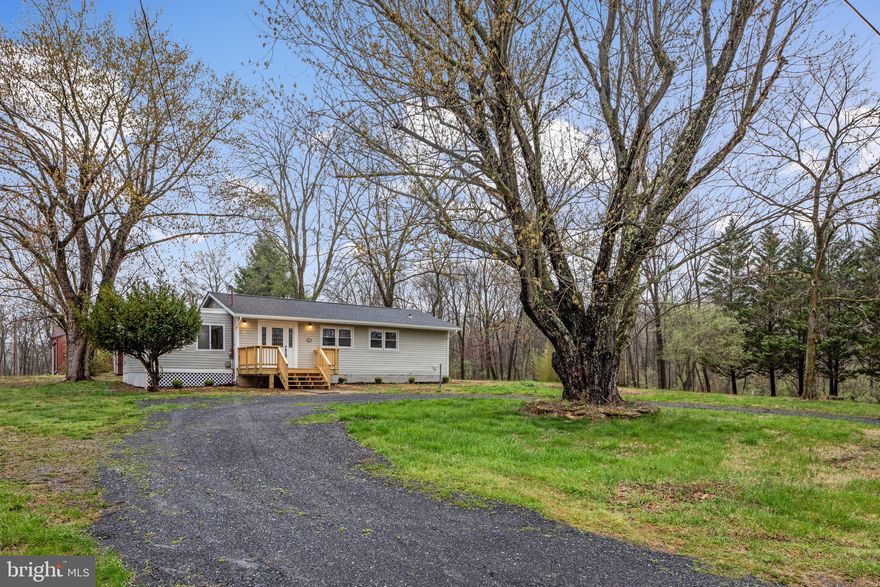 Beautifully remodeled 1500 sqft home just a few houses down from Crystal Lake Beach!  Situated on a nice open half acre lot in prime location in Shawneeland, just minutes to the entrance, playgrounds, lake, and more!  Inside this home features 3 Bedrooms, 2 bathrooms, a new kitchen with granite counters, new bathrooms, flooring, and a bright and wonderful open main living space.  New roof, gutters, deck, instant hot water, and more.  Come see this rare combination of updates, living space, lot, and location, at a price you cant get in the area! Owner licensed agent.