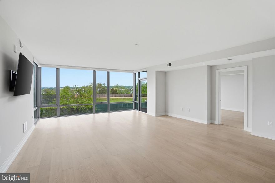 Not all residences at The Muse are created equal—this is one of the most desirable luxury condos in Old Town Alexandria.

Filled with natural light, this expansive residence features floor-to-ceiling windows, an open-concept layout, and a private balcony with green space and Potomac River views. The seamless flow between the living, dining, and kitchen areas creates an ideal setting for both everyday living and effortless entertaining.

The modern kitchen is designed to impress, offering an oversized island, sleek cabinetry, and premium appliances. The primary suite provides a quiet retreat with walk-through closets and a spa-inspired bath with double vanities and a glass-enclosed shower. Additional bedrooms offer flexibility for guests, a home office, or evolving lifestyle needs.

Residents of The Muse enjoy an amenity-rich lifestyle including a rooftop terrace with panoramic river and skyline views, outdoor lounge and grilling areas, fitness center, resident lounge, concierge-style lobby, secure garage parking, and private storage.

Located in the heart of Old Town Alexandria, this home is just moments from the waterfront, nearby marina, restaurants, coffee shops, boutiques, and scenic trails. Enjoy a highly walkable lifestyle with convenient access to waterfront dining, boating, and outdoor recreation.

Ideally positioned for commuters and travelers, with easy access to Reagan National Airport, Dulles International Airport, Washington, DC, National Landing, and major commuter routes.

This is a rare opportunity to own a modern waterfront condo in Old Town Alexandria with Potomac River views, balcony, garage parking, luxury amenities, and marina access nearby—where location, design, and lifestyle come together.