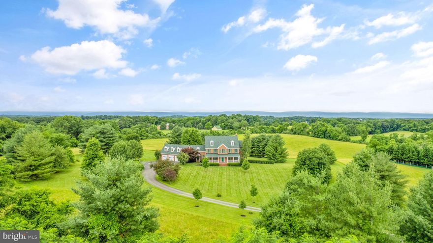 PRICE IMPROVEMENT---6 BD, 4.5 BA, 5,660 sq/ft , custom built, architect designed 4 side brick colonial on 12 acres.  Classic Virginia colonial floor plan with high ceilings, wide staircases, hardwood floors, open foyer and custom River-Rock fireplace. Fine finish throughout with gracious features such crown molding, wainscoting, and doorway transoms.  Large family room with an abundance of windows and natural lighting opening up to spectacular mountain views.  Kitchen opens up to the family room, designed around the hearth, perfect for family or friend gatherings.  Spacious adjoining room  extents a wide range  of possibilities - main bedroom, sunroom, office.     Second level has three enormous secondary bedrooms, hall bath, play/ school room or office area leading to roughed in in-law suite over 3 car garage.  Also primary bedroom suite with oversized walk-in closest, generous primary bath with soaking tub and separate walk-in shower,  water closet.   Upper third level with an additional three rooms currently used for bedrooms and a dance studio,  and full bath.  Lower level features a walk out basement with French doors, a full bath, is  studded and insulated awaiting your final plan or choice.   Outside features a wide mahogany- floored fan cooled front porch with view of perfectly manicured and landscaped front.  Screened in back porch to relax to the sites and smells of nature after work.  Ample parking and storage with 3 car garage and solid fun shed. Located in Waterford VA, historic  site and home to the  nationally famous  Waterford Fair held every October.  Conveniently located on a quiet, state-maintained paved road, this property offers a unique opportunity to make it your own while enjoying what the original owners had substantially created for their family. Enormous rooms, top-of-the line systems are in prime condition---3 Zoned HVAC’s, over-sized hot water heater, new roof, owned 1000 gallon buried propane tank, central vacuum system and solid construction throughout.