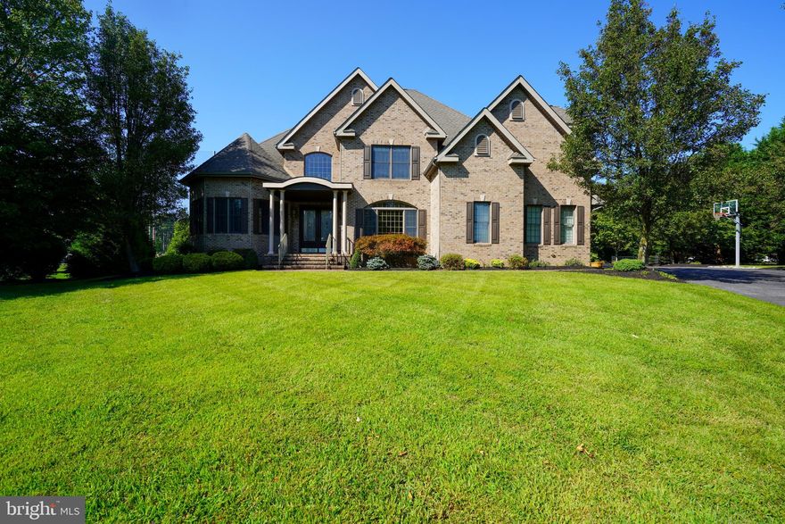 LUXURY LIVING IS YOURS from this exquisite custom-built, Tuscan-inspired home situated in sought-after Kings Creek Country Club. Nestled on a serene half-acre cul-de-sac lot, this residence boasts six bedrooms, including the luxurious first-floor primary featuring a gas fireplace, jetted soaking tub, walk-in shower, double vanity, & walk-in closet, and 5 additional bedrooms on the second floor, 4 with en suite baths. Enjoy hardwood and tile flooring throughout living areas, formal dining and living rooms, sunroom with bar area and dining area. The cozy family room showcases a stone gas fireplace and is open to the gourmet kitchen with granite countertops, Wolf gas range, warming drawers, 3 dishwashers, and large breakfast bar/island. The fully finished basement boasts a game room, gym and several finished bonus rooms with endless possibilities such as a yoga studio, playroom, art studio – flex rooms at their finest. The rear deck offers a relaxing setting to enjoy alfresco dining, beautiful sunsets, or soaking in the hot tub. The meticulously landscaped yard enhances the natural beauty of the surroundings, adding to this home’s appeal. Indoors and out, this home invites you to stay, relax, and create your exceptional coastal lifestyle in amenity-rich Kings Creek Country Club, nestled next to downtown Rehoboth Beach. Kings Creek membership optional. Call and schedule your showing today!