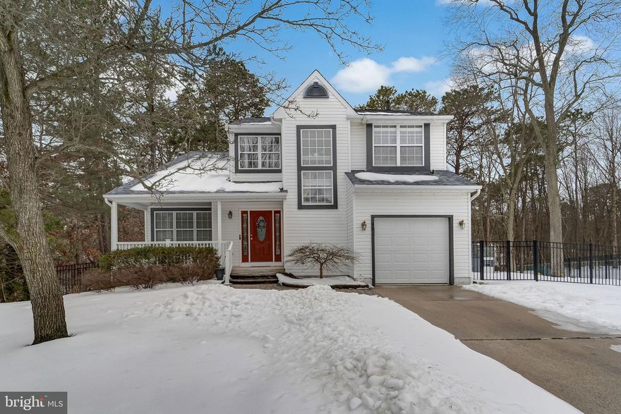 Located on a quiet cul-de-sac, this stunning Colonial blends timeless elegance with meaningful updates and modern comfort. From the moment you arrive, the inviting front porch create a warm and impressive welcome. Step inside to a dramatic two-story foyer that sets the tone for the spacious and thoughtfully designed interior. The formal living room features vaulted ceilings and recessed lighting, creating an open and airy atmosphere that flows seamlessly into the formal dining room accented with crown molding — ideal for entertaining and special gatherings. The heart of the home is the gourmet kitchen, offering granite countertops, tile backsplash, stainless steel appliances, and a comfortable breakfast area perfect for everyday living. Just off the kitchen, the family room provides a cozy yet spacious setting and opens through glass sliders to a wood deck with pergola. The backyard offers wooded views and privacy, creating the perfect setting for relaxing evenings or hosting guests. The home has been significantly improved with brand new flooring throughout, giving every room a fresh, modern feel. A new roof has also been installed, providing added value and long-term peace of mind for the next homeowner. The main level also includes a convenient laundry area and an updated powder room, enhancing both function and style. Upstairs, the primary suite serves as a true retreat, featuring a vaulted ceiling, recessed lighting, and a spacious walk-in closet. The en-suite bath offers dual sink vanity with granite countertops, a jetted jacuzzi tub, and a separate stall shower. Two additional well-sized bedrooms and an updated hall bath with granite vanity complete the upper level. The finished basement expands your living and entertaining space, featuring Pergo flooring, a custom bar, and a wet bar. Additional storage space ensures everything has its place. Major systems including the heater, central air, and hot water heater have been updated in recent years, adding to the home's overall value and efficiency. Conveniently located near major roadways, shopping, and dining, this home offers the perfect balance of privacy and accessibility. Move-in ready with key upgrades already completed, this beautifully maintained home is ready for its next chapter.