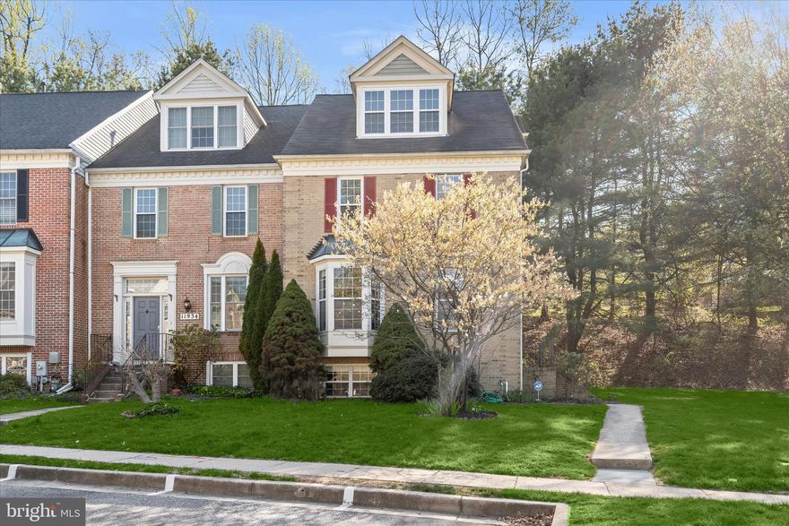 Introducing this sun-filled end-of-group townhome in the highly sought-after Chapel Gate neighborhood in Mays Chapel, offering four bedrooms and three and a half bathrooms across four finished levels. Step inside to an inviting main level featuring a neutral color palette, recessed lighting, and rich hardwood floors. The foyer includes a convenient coat closet and half bathroom. Prepare your favorite meals in the updated kitchen equipped with stainless steel appliances, including a gas range, black granite countertops, tile backsplash, maple cabinetry, pantry, and space for a breakfast table. The open-concept dining and living areas are ideal for everyday living and entertaining, highlighted by a cozy wood-burning fireplace and access to a rear deck backing to trees for added privacy and tranquility. Upstairs, the primary bedroom suite showcases a soaring vaulted ceiling, walk-in closet, and a well-appointed ensuite bathroom with a soaking tub, walk-in shower, skylight, and dual-sink vanity. Two additional bedrooms, a full hall bathroom, and a laundry closet complete this level. The top floor offers a versatile loft with two skylights, ideal for a home office, lounge, or additional bedroom. The finished lower level expands the living space with a recreation room, third full bathroom, and a fourth bedroom featuring a walk-in closet. Conveniently located just minutes from shopping, dining, and everyday amenities, with quick access to major commuter routes 83 and 695.