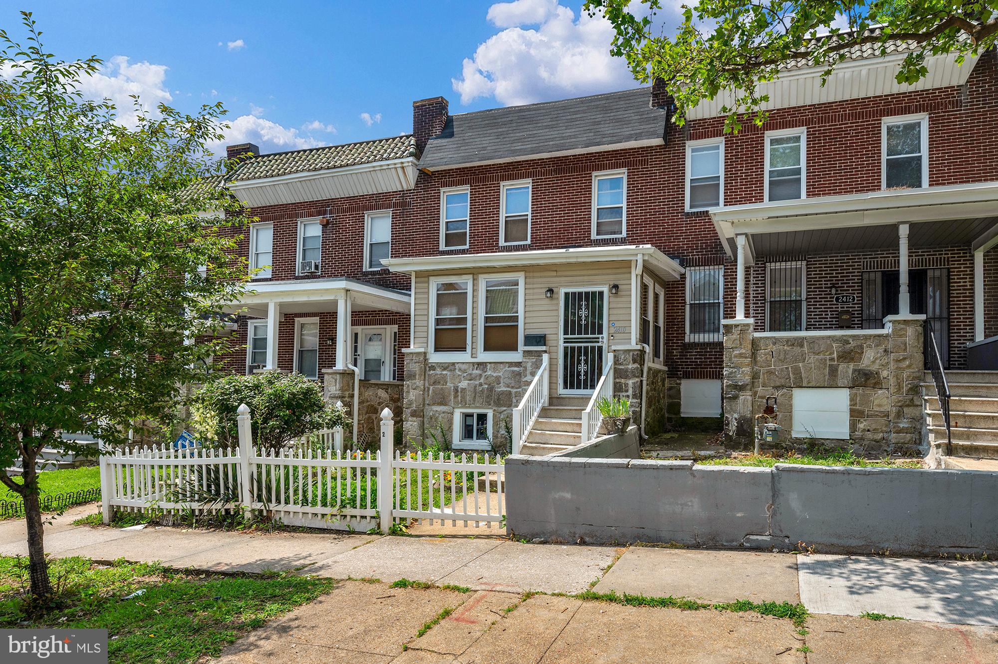 Welcome home to this charming 4-bedroom, 1 full and 2 half bathroom rowhome in the heart of Baltimore! Step inside to find gorgeous hardwood floors flowing throughout the entire home and a beautifully enclosed front porch that serves as a sun-filled bonus space. The main level offers a spacious living room with a cozy fireplace, a formal dining room perfect for gatherings, and a well-appointed kitchen featuring stainless steel appliances. A convenient half bath rounds out the first floor. Upstairs, you’ll find four comfortable bedrooms, a full bathroom, and access to a private back deck — the perfect spot for morning coffee or evening relaxation. The finished basement provides additional living space, a second half bath, and a laundry room, making it ideal for a rec room, home office, or guest area. Out back, enjoy the convenience of a two-car parking pad. Don’t miss your chance to own this beautiful and functional home close to all that Baltimore has to offer!