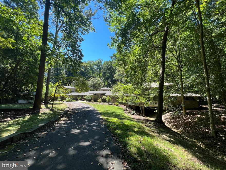 Exquisite Asian-Inspired Retreat on a Secluded 5-Acre Oasis
Tucked away in one of the most private and highly sought-after Great Falls communities, this magnificent 5-bedroom, 4.5-bathroom estate is a true sanctuary of luxury living. Inspired by Asian design, this custom-built masterpiece combines timeless elegance with modern comforts to offer an unparalleled living experience.

Elegant Living Spaces
Step inside and be greeted by an abundance of natural light that flows through the expansive great room with soaring, two story clerestory ceiling, adorned with numerous windows and a captivating wood-burning fireplace. The open-concept design creates an inviting atmosphere perfect for both relaxation and entertaining.

Indoor-Outdoor Bliss
Embrace the Great Falls lifestyle with multiple decks that seamlessly blend the interior with the serene outdoors. Discover a walk-in pool surrounded by lush landscaping, offering a tranquil respite or a lively gathering place for family and friends for personal or business entertaining.

Impressive Master Suite
The private master suite occupies its own level, complete with vaulted ceiling, his and hers customized walk-in closets, and two private decks overlooking the property. The luxurious master bathroom is a spa-like retreat, featuring a soaking tub, a spacious shower, and bidet.  The two bedrooms in the West wing occupy a bridge spanning a picturesque dry gully.

Thoughtful Amenities
This home boasts a large private office with built-ins and a separate entrance  that is perfect for remote work or quiet contemplation. A game room overlooking the expansive backyard provides a recreational escape for all ages.

Endless Outdoor Possibilities
With 5 sprawling acres, you have the canvas to further create your dream oasis. The circular driveway and 4-car garage ensure ample parking for guests. Host gatherings in style, from intimate family gatherings to grand events, with plenty of space for everyone.

Unmatched Location
Located on a secluded private street, although less than ten minutes from the center of Great Falls village, with ample and varied shopping and restaurants, you'll enjoy the utmost privacy while remaining within easy reach of D.C., Tysons Corner, Loudoun County and nearby attractions, schools, and amenities. This is a rare opportunity to own a California-inspired estate on an expansive 5-acre lot in one of the most exclusive neighborhoods in the area. The home is located in the Great Falls-Cooper-Langley educational pyramid.

Additional Features
Circular driveway with guest parking
Custom Asian-inspired architectural details
Game room with built-ins
Two 2-car garages for the auto enthusiast
Impeccably landscaped grounds
Walk-in pool for relaxation and recreation

Don't miss your chance to experience the serenity and luxury of this unique Asian-inspired estate. Schedule a private tour today and discover the extraordinary lifestyle that awaits you in this secluded haven.