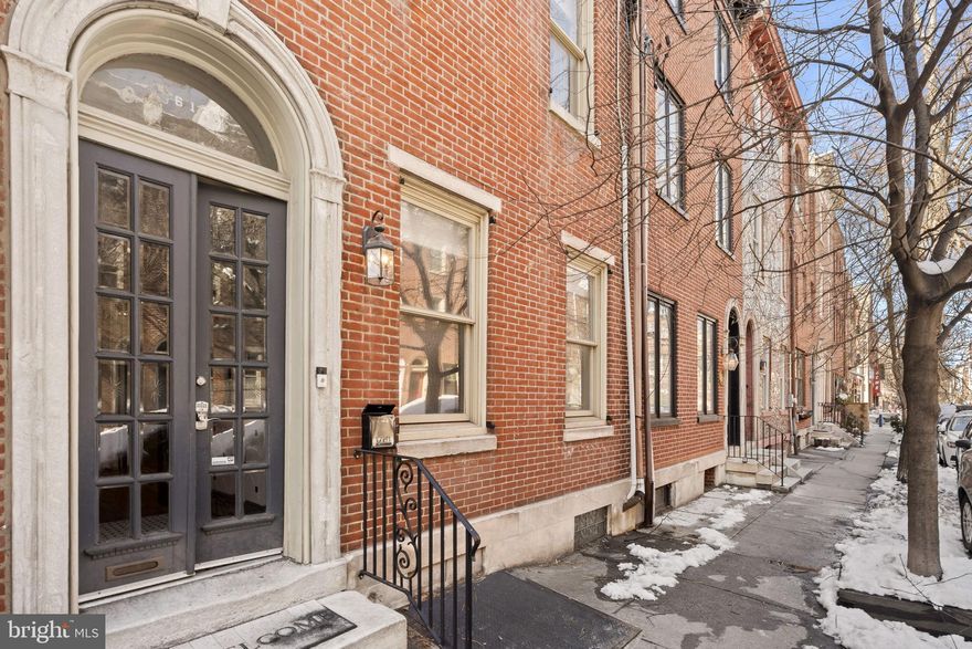 614 S 10th Street offers a rare combination of historic character, remarkable scale, and an outdoor setting that is nearly impossible to find in the heart of the city. Your pantry is at the corner!  Located moments from the iconic 9th Street Market, Whole Foods, Acme, neighborhood cafés, and Palumbo Recreation Center, the home places everyday conveniences at your doorstep.  Some of Philadelphia’s most celebrated theaters and Center City cultural destinations are such a short distance away, placing dining, entertainment, and the arts within easy reach.

Spanning from street to street, with an extraordinary garden and coveted one to two car garage parking, these irreplaceable features immediately make a lasting impression. A tiled vestibule opens into a first level filled with warmth and architectural presence. Exposed brick, crown moulding, original hardwood flooring on the first and second level, and soaring ceilings create a sense of openness and timeless charm. Substantial 18-inch masonry walls add to the home’s quiet comfort, while large windows allow natural light to move beautifully through the space. Six fireplaces throughout the home further highlight its character.

The main living level is designed for both everyday living and memorable gatherings. The living room, dining area, and chef’s kitchen connect seamlessly, creating an inviting open environment. The kitchen is thoughtfully equipped with double wall ovens, a cooktop, tile backsplash, and abundant cabinetry, offering both functionality and style. A well-positioned half bath adds convenience to the level.

In addition to location, what truly sets this property apart is the extraordinary outdoor environment. The home opens to a massive courtyard that feels like a peaceful sanctuary in the middle of the city. With nearly 1,000 square feet of outdoor space, the setting is expansive and incredibly rare for a residential property in Philadelphia. There is a deck over the garage that overlooks the beautifully designed garden patio, offering a tranquil oasis to relax and entertain. 

Inside, the connection between interior living spaces and the garden creates a natural flow that makes both everyday life and entertaining feel effortless.

The second level introduces a bright morning room overlooking the garden, a peaceful place to start the day capturing views of the colorful murals of Philadelphia’s famed Magic Gardens or use it as an office or writing room.  Two spacious bedrooms, each with its own fireplace, share this level along with a full bath featuring a dual vanity and a conveniently located laundry area. 

The uppermost level feels like its own enclave within the home. Set apart from the main living areas - this area offers another open living area with a fireplace and built-ins, an additional bedroom with its own fireplace, a full bath and additional large open room, creating possibilities for a studio, guest space, or an additional bedroom.

The home offers exceptional versatility and generous living space suited to a variety of lifestyles and needs. Original architectural details, substantial construction, and expansive indoor-outdoor living come together to create a residence that feels both timeless and welcoming.

In one of Philadelphia’s most vibrant and culturally rich neighborhoods, 614 S 10th Street presents a truly distinctive opportunity where you can have it all. With its massive outdoor space, garage parking, and a remarkable amount of living space, this home offers the freedom to live, work, relax, and entertain without compromise.  Just moments to markets, theaters, dining, and Center City destinations, this home offers a unique blend of energy, character, and peaceful retreat, a place designed to be enjoyed through every chapter of life  Properties offering this level of space, character, extraordinary outdoor living, and garage parking rarely come to market in this neighborhood.