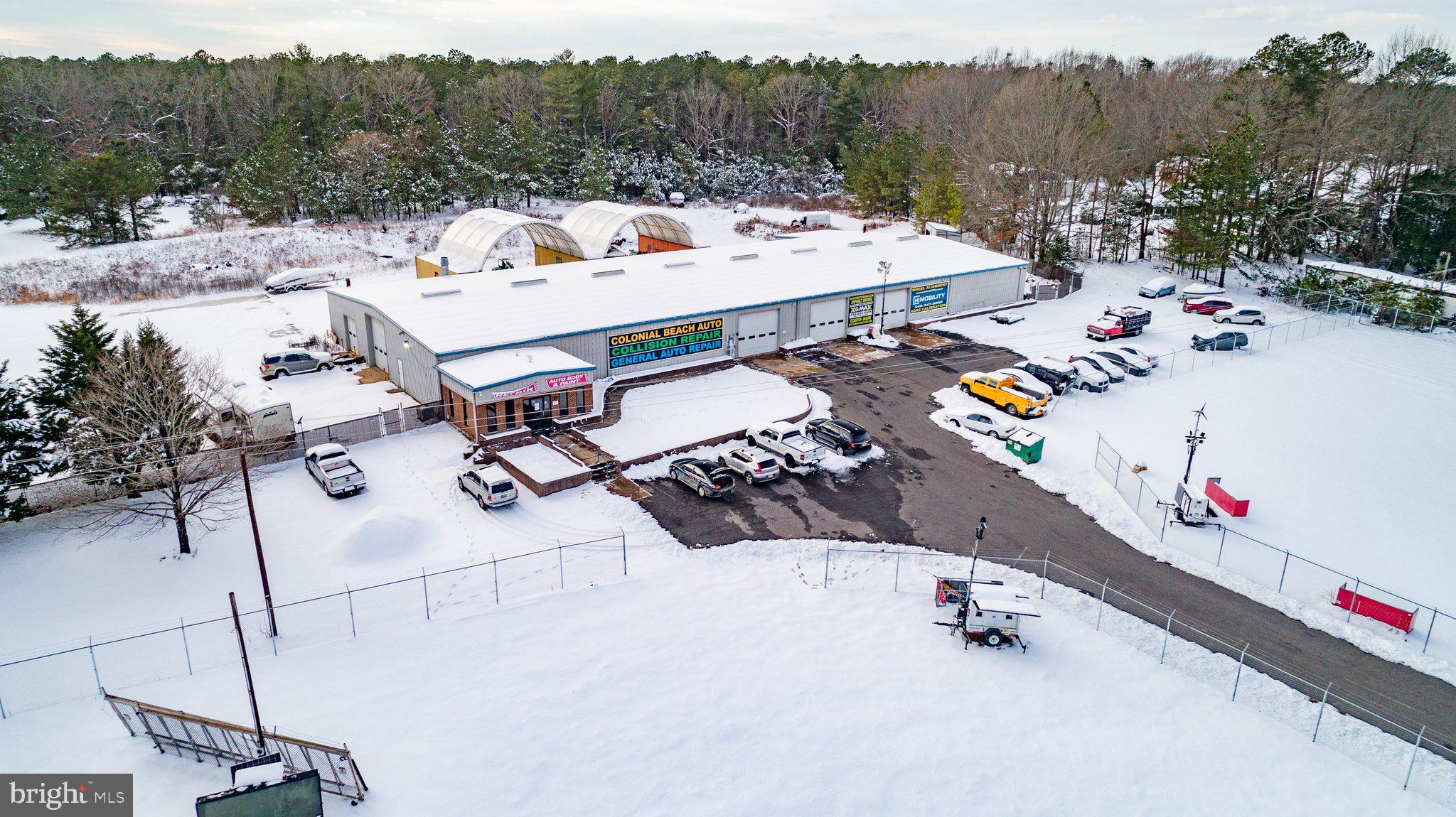 Rare and exceptional industrial warehouse property located at 913 Longfield Rd in Colonial Beach VA. This expansive 7.27-acre site features a 16,936 sq ft warehouse, complemented by 558 sq ft of office space, making it an ideal location for various industrial or commercial operations. With its strategic location, versatile facility, and potential for a wide range of commercial uses, this property offers a unique opportunity for businesses seeking space in the Colonial Beach area. The property includes 2 front fenced lots, each 30,000 sq ft, and 1 rear fenced lot spanning 2.6 acres, offering ample secure space for operations or expansion. The property comes with a valuable in-place special use permit for auto body repair, providing immediate flexibility for businesses in this industry.