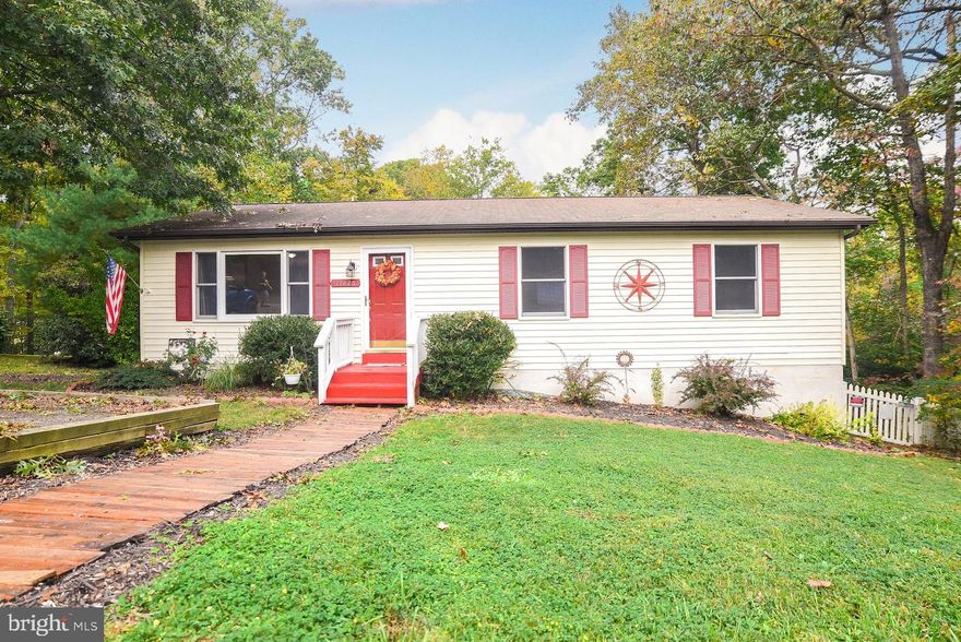 "Once upon a time there were three Bears, who lived together in a house of their own, in a wood" - Make the fairytale come true in this  "Just Right" rambler.  One-level living in this open floor plan with gorgeous and durable NEW vinyl plank flooring throughout.  Porridge is made easy in the spacious kitchen with  island/breakfast bar and room for a large table. Granite counters, soft close, upgraded cabinets and NEW refrigerator. Sliding door from the dining area leads to the composite deck with pergola overlooking private, fenced yard with a large shed.  Light and airy, this homes has three bedrooms including a primary bedroom with attached tile bathroom.  Plus, NEW HVAC and NEW water heater.  Enjoy all that the Chesapeake Ranch Estates community offers including water access onto the Chesapeake Bay and Lake Lariat, community beach, pier, boat ramp, tot lot, ball fields/courts and community grounds. Convenient to shopping, dining and PAX.