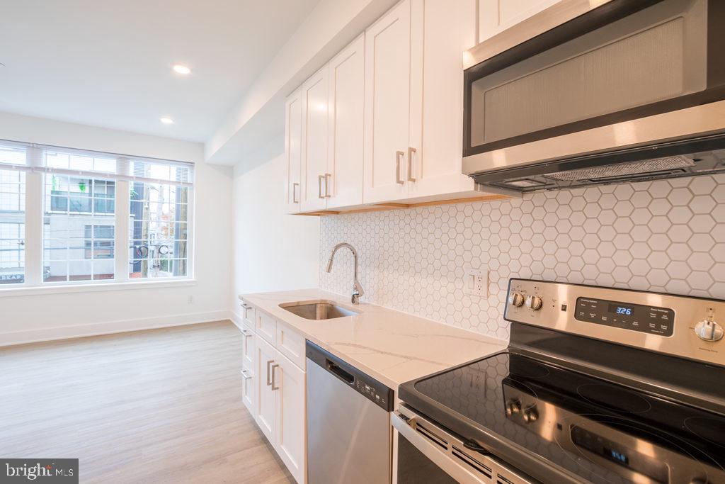 Available Now!
Don’t miss the chance to live in this new apartment building with a prime location in the heart of Fishtown! Situated within walking distance from staple Philadelphia attractions like La Colombe Coffee Roasters, Wm. Mulherin’s Sons, Laser Wolf, and Jinxed Antique Furniture store, you are sure to enjoy the immediate neighborhood. This 1 bedroom, 1 bathroom unit boasts large windows flooding the space with natural light, central air, an in-unit washer/dryer, hardwood flooring and modern finishes throughout. The kitchen features pristine white cabinets and white tile backsplash, quartz countertops, as well as stainless steel appliances. The bedroom includes an elevated glass window allowing diffused natural light and a spacious closet for storage. The bathroom has a sleek vanity, natural wood cabinetry and a full shower/tub with black contrasting tile. Last but not least, head up to the shared roof deck to take in beautiful city views.
Lease Terms: Generally, 1st month, and 1 month security deposit due at, or prior to, lease signing. Other terms may be required by Landlord such as last month’s rent upfront. $65 application fee per applicant. electricity, gas (if applicable), cable/internet and $10/mo technology fee. Water is a flat monthly fee of $60. $25 service fee plus cost of the air filter will be charged quarterly for routine air filter replacement. Landlord Requirements: Applicants to make 3x the monthly rent in verifiable gross income, credit history to be considered, no evictions within the past 5 years, and must have a verifiable rental history with on-time rental payments. Exceptions to this criteria may exist under the law and will be considered. Cosigners will be considered.
*Price reflects the net effective rent after a 1-month credit is applied at $1,500/mo.
*Listing Photos are of a model unit with similar layout, finishes will match, layout may differ slightly
*1 dog OK (max 45 lbs), NO cats – $50/mo pet rent
*Internet wired for Comcast & Verizon