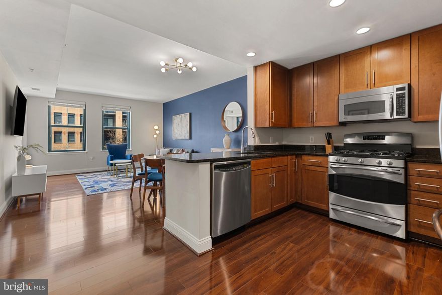 Incredible opportunity to own a rare one bedroom + den at The Henry in North Old Town!! This bright and modern condo features beautiful hardwood flooring throughout, oversized windows, stainless steel appliances + granite counters, spacious bathroom, built-out walk-in closet, and in-unit laundry. The open-concept kitchen overlooks the living and dining areas, leading to a private balcony with peaceful interior views of The Henry courtyard and green space.  Natural light fills both the bedroom and versatile den, which can easily serve as a home office, guest space, or even a second bedroom.  This unique condo is an end unit and thus offers two walls with windows for more natural light! Closet for storage as you enter the condo + additional storage cabinet in bathroom. Washer/Dryer replaced in 2023. The Henry offers an array of top-tier amenities, including a residents’ lounge with a movie room, pool table, kitchen, and library. Enjoy the state of the art fitness center, gated courtyard, two rooftop terraces, secure assigned parking and storage unit, and a concierge at the front desk for added convenience and security. The Henry offers city living at its very best - located just blocks from many beloved local shops and restaurants, Trader Joe’s and Harris Teeter grocery stores, and easy commuting from the Braddock Road Metro into DC. Less than one block to Starbucks, Bastille Brasserie & Bar, Studio Barre and community park or stroll to the Potomac River, King Street, Oronoco Bay Park and more!! Less than 4 miles to National Airport!