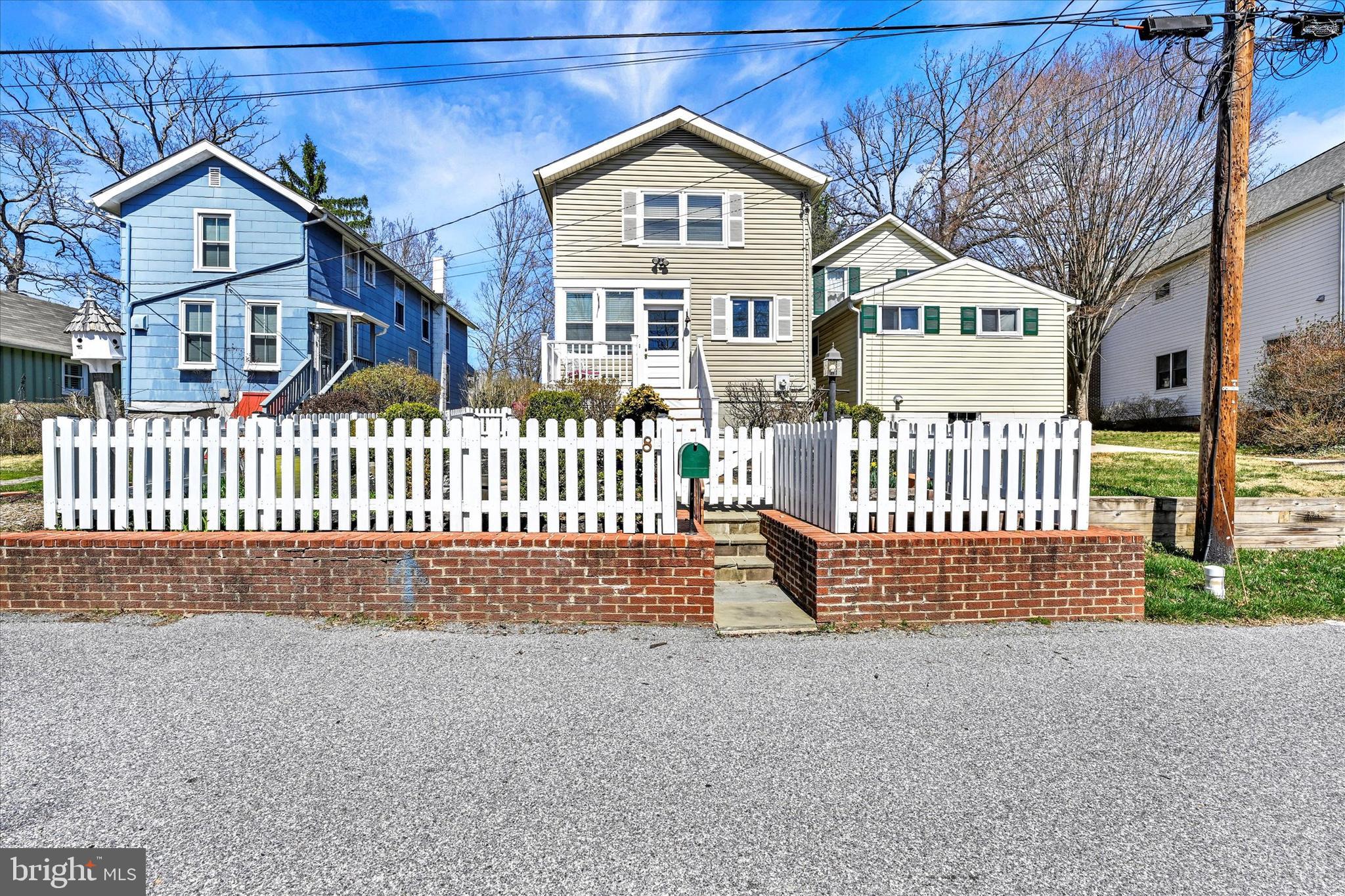 Welcome to 8 Fiske Ave—brimming with charm, light, and peaceful vibes. Tucked on a quiet dead-end street in Historic Glyndon, this 3-bed, 2.5-bath home backs to Glyndon Park with open space, jungle gyms, and charming wooded views. Inside, the open layout flows with hardwood floors and natural light. A gas fireplace anchors the central living and dining rooms while a pellet stove creates ambiance and radiates warmth throughout the entire main living space. The kitchen offers granite counters, stainless appliances, and a sunny breakfast nook. Upstairs, you will find a spacious primary suite including a generous walk-in closet and two additional in room closets and an en-suite with dual vessel sinks along with 2 additional bedrooms and another full bath. Enjoy the screened-in porch with peaceful views, a fenced front yard, and two dedicated street parking spots directly out front. Schedule your tour today to visit this special home, in a truly special setting!