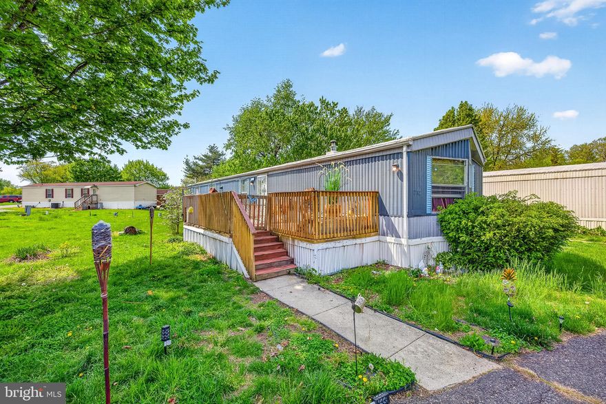 Spacious and full of potential, this mobile home features multiple bedrooms, two full bathrooms, and a functional layout designed for comfortable living. Enjoy a bright kitchen, a cozy primary bedroom, and a versatile flex room perfect for a home office, guest space, or hobby area. Step outside to a large private deck, ideal for relaxing or entertaining, along with a storage shed for added convenience. Nestled on a lot with mature trees and open green space, this home offers both comfort and opportunity. Schedule your tour today!