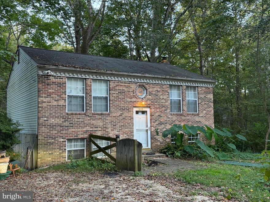 Large private lot.  Home needs work and is sold in 'as is' condition. 2BR, 1BA up.  Previously there were two BRs on the lower level.  Doors were removed.