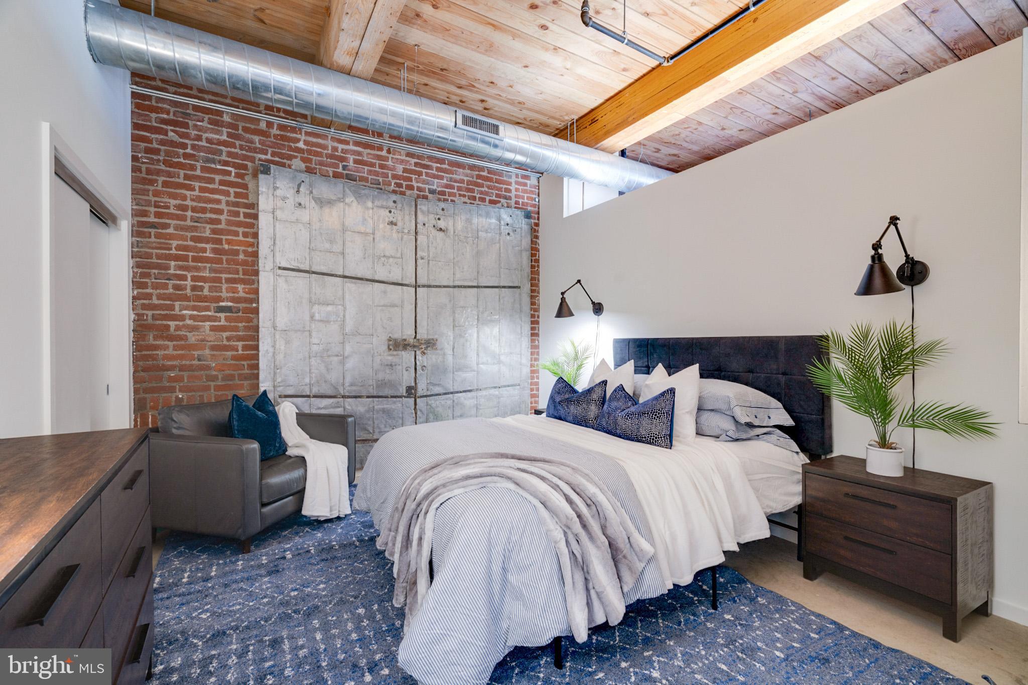 Welcome to the top-floor, one-bedroom, one-bath condo in the renowned Memphis Flats development, an enticing opportunity in vibrant Fishtown. This loft unit, spanning 994 square feet, showcases striking features such as 11-foot ceilings with giant timber beams and columns, and warm concrete floors. Expansive windows flood the interior with natural light, creating an airy ambiance. The modern kitchen features stainless steel appliances, and a Bosch washer and dryer offer convenient laundry care. Enjoy the convenience of a designated off-street parking space and a generously sized storage unit. Residents can access a fitness center and bicycle parking. With its prime location in the heart of Fishtown, known for its lively atmosphere and trendy dining spots, this condo offers an unparalleled urban living experience.