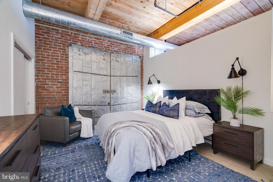 Welcome to the top-floor, one-bedroom, one-bath condo in the renowned Memphis Flats development, an enticing opportunity in vibrant Fishtown. This loft unit, spanning 994 square feet, showcases striking features such as 11-foot ceilings with giant timber beams and columns, and warm concrete floors. Expansive windows flood the interior with natural light, creating an airy ambiance. The modern kitchen features stainless steel appliances, and a Bosch washer and dryer offer convenient laundry care. Enjoy the convenience of a designated off-street parking space and a generously sized storage unit. Residents can access a fitness center and bicycle parking. With its prime location in the heart of Fishtown, known for its lively atmosphere and trendy dining spots, this condo offers an unparalleled urban living experience.