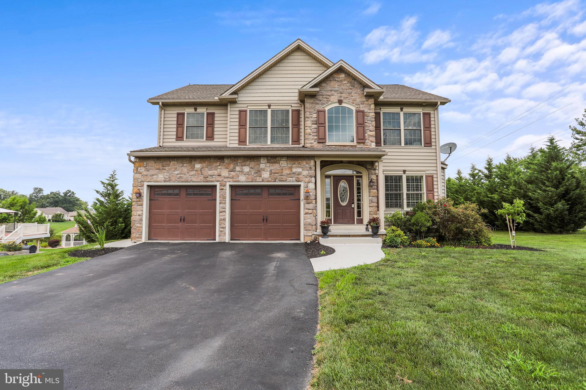 WELCOME TO MARTINS RIDGE IN SOUTH HANOVER...with loads of curb appeal and a PREMIUM corner lot serviced with public utilities and natural gas heating. With over half an acre there is plenty of room to roam and about as level as you'll find. The evening sunsets from the composite deck are breathtaking. Once you stroll inside there's plenty of room w/about 2300 sq ft boasting 4 bedrooms and I love the fact that the laundry is on the 2nd floor...how convenient. The open main living area is complimented with a formal dining area, spacious family room featuring a gas fireplace. This former builders model comes with "loads of extras" including double oven, cooktop and note that all appliances are included. The island in the kitchen is perfect to enjoy lunch at w/sliders to the backyard. The lower level is almost complete w/a walk-out to the backyard. Drop a ceiling in and you'll have tons of additional living space...the wide plank laminate flooring is already installed for you and is really nice. You'll be happy to know that this home is within minutes from the MD line - so commuting to Baltimore, Owings Mills, Frederick or York is super realistic.