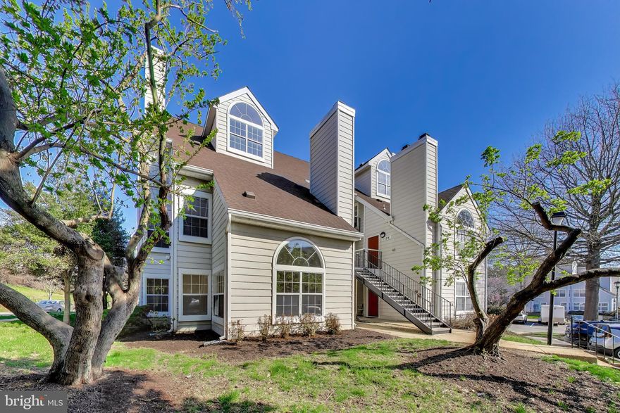 Don't let the price fool you. This bright 2BD/2BA ground-floor condo in Vistas at New Bowie Town Center has a living room that stops people mid-tour -- vaulted ceiling, a signature arched window, a wood-burning fireplace, and new LVP flooring catching the afternoon light. Multiple windows bring in greenery views and sunlight throughout the day. Fresh paint, updated kitchen with Corian countertops and replacement appliances, two well-sized bedrooms. The HOA covers exterior building and common area maintenance, lawn care, snow removal, and trash -- nothing to maintain outside your front door. Community amenities include a jog/walk path, picnic area, and tot lots. Open parking. About a mile to Bowie Town Center shopping and restaurants. Conventional or cash financing.