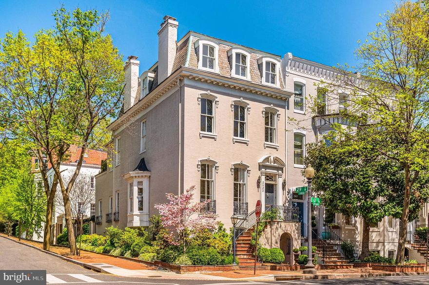 A seamless blend of bygone romance and today’s luxury, this distinguished, semi-detached five Bedroom French-influenced Victorian townhome is prominently situated on a picturesque corner in Georgetown’s prestigious East Village. Eight-foot-tall windows and 12’ ceilings ensure that abundant Southern and Western sunlight fill every room of the main level throughout the day. Formal Living and Dining Rooms feature matching fireplaces, while floor-to-ceiling lacquer finished bookcases complete the Dining Room. The extraordinary Kitchen/Family Room is designed for contemporary living with a huge, marble-topped center island, generous banquette seating for informal dining and lounging and seamless indoor-outdoor flow via three sets of French doors that open to the private, walled garden and garage. 

Upstairs, an airy, full-floor Primary Bedroom Suite features an expansive Bedroom and generous Sitting Room, both with fireplaces, sumptuous Bathroom and romantic, private Terrace. Three additional bedrooms are located on the top level. 

The fully-finished English Basement offers a separate front entry as well as an interior stairway to seamlessly integrate this part of the home, offering a bright, spacious Family Room, generous fifth Bedroom and luxurious marble Bathroom. Welcome home!