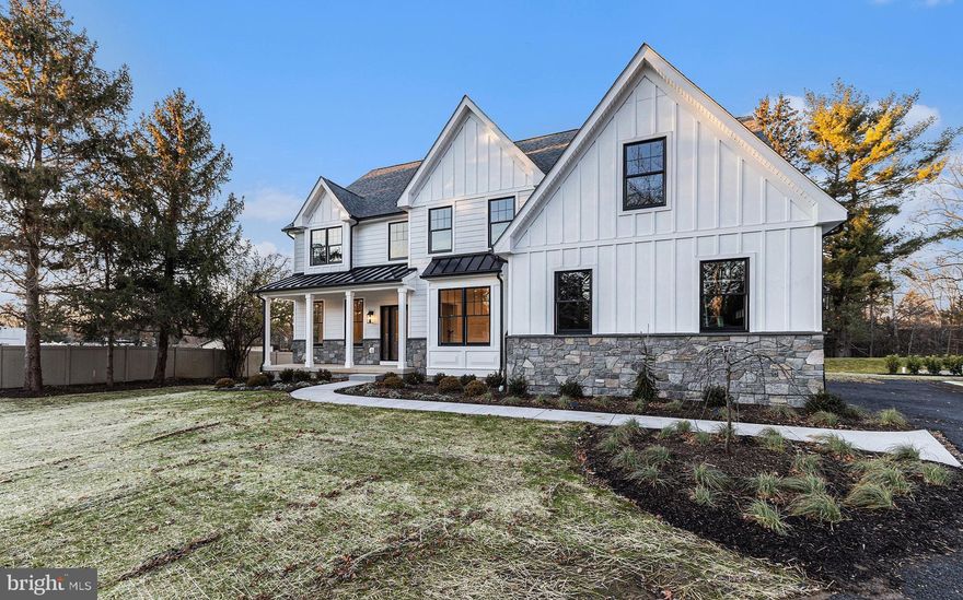 Back on the market following a change in buyer circumstances, presenting a rare second opportunity to own this exceptional new construction home.
Freshly Completed, 409 W. Butler Pike is a brand-new custom home blending refined craftsmanship with professionally curated interiors. Enjoy 4 bedrooms, 3 full baths, 2 half baths, and an expansive three-car garage. Located in the sought after Colonial School District this home is designed for modern living and situated on a beautiful full acre lot featuring mature trees and a flat back yard. Designed by R.A. Hoffman Architects and built by Blundin Builders with Parec Properties, the attention to detail in planning and execution will truly set this home apart. Just minutes from the heart of Ambler, the location offers easy access to a vibrant and charming small-town center.
Enter from the covered front porch through to the two-story foyer where you’ll find a private study with French doors to your left, perfect for working from home, and dining room to your right. Following along the main hall you pass an elegant staircase on your right, finished with white oak treads and custom newel posts, tucked away to your left is the formal powder room and coat closet.
The heart of the home is found at the rear, where the entry hall opens into a spacious family room and eat in kitchen that flow together seamlessly. Framed by expansive windows that flood the space with natural light, the kitchen is a true showpiece. Thoughtfully designed to combine function and style, it features a dramatic range wall with a Thermador gas cooktop, an oversized custom hood, and zellige tile backsplash. Warm wood lower cabinets are paired with crisp white uppers creating a timeless and updated look. An oversized island with seating provides the perfect gathering space, while a dedicated coffee bar, open wood accent shelving, and gleaming quartz countertops complete the space. Connecting the kitchen to your dining room for effortless entertaining, is an expansive butler's pantry featuring more custom cabinetry, quartz counters, a bar sink, and a built-in beverage fridge. Or dine alfresco, stepping outside onto your covered Trex composite deck, an ideal setting for warm-weather get-togethers. Rounding out the first floor and situated just off the kitchen is a convenient family entrance/ mud-room, complete with another half bath, walk-in pantry and custom built-in cubbies and hooks, providing the perfect drop zone for everyday organization just off the garage.
Ascending the staircase, you’ll find a spacious primary suite featuring a dramatic volume ceiling and two generously sized walk-in closets with custom closet organization systems. The luxurious primary bathroom offers a serene retreat, complete with a soaking tub, a large spa-style shower, and custom dual vanity for a truly elevated experience. Bedroom 2 offers the privacy of its own en-suite full bathroom with a tiled shower and custom vanity. Bedrooms 3 and 4 each feature walk-in closets and share a well-appointed Jack-and-Jill bathroom. Also on the second floor is a convenient laundry room, complete with a utility sink, built-in cabinetry, a folding area, and a storage closet, designed for maximum functionality.
Additional highlights include black Andersen 400-series windows, Hardie Plank siding with board and batten accents, a 25-year architectural shingle roof, and upgraded standing seam metal roofs on the front and side porches. Inside, custom lighting, designer-selected plumbing fixtures and upgraded marble and tile selection layouts add a refined touch throughout. A dual-zone HVAC system ensures year-round comfort. These carefully curated finishes and systems reflect a level of quality and sophistication far beyond typical “builder-grade” home.