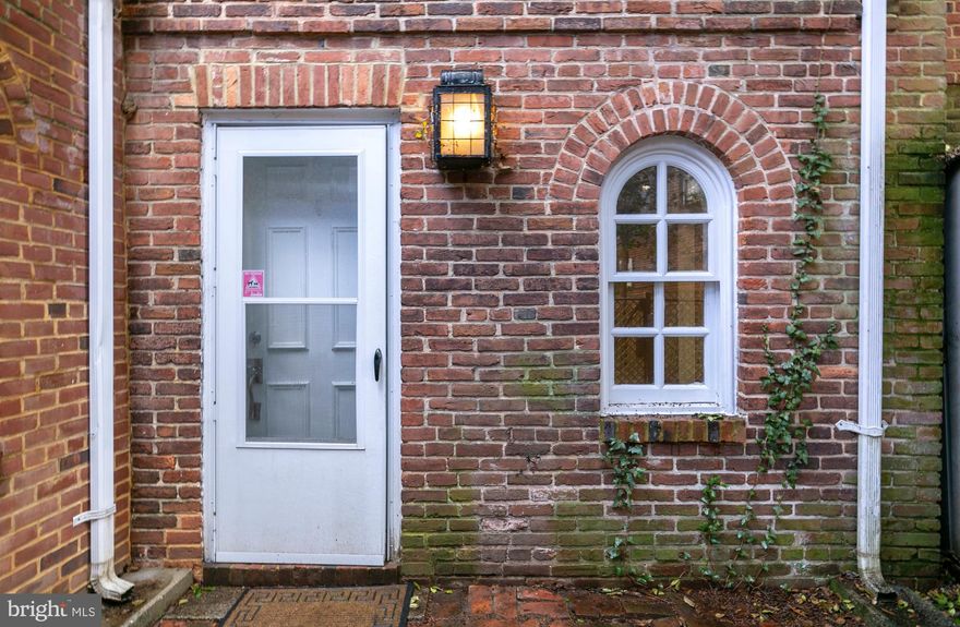 Experience the allure of history and modernity in this captivating downtown city house. Embrace the opportunity to reside in a truly distinctive 1-bedroom, 1-bathroom gem. Situated conveniently just off State Circle in the very heart of downtown, this residence places you in close proximity to all the Annapolis hotspots you desire - from charming shops to delectable restaurants, immersing you in the dynamic pulse of the city.

Elegance and heritage converge within as vaulted ceilings and exposed brick walls grace the interior. An impeccably updated, contemporary kitchen stands ready to serve your culinary aspirations, while the inviting living room is adorned with a brick fireplace though no longer functional; it still  creates an enticing ambiance that beckons relaxation at home.

The  pièce de résistance is the two-story solarium that overlooks the picturesque brick gate courtyard. Here, you can relish both privacy and an exquisite view that adds an extra layer of charm to this already enchanting residence. 

Fun Annapolis tidbit;  Renowned Annapolis artist,  Nancy Hammond once used this space as her Artist Studio.
NOTE: The property is currently occupied. Please DO NOT walk through the gates without an appointment.