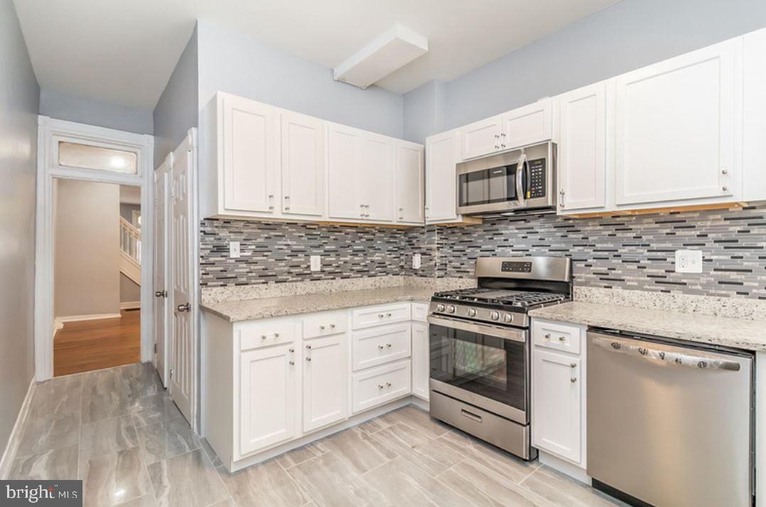 Renovated townhome, completely remodeled kitchen including stainless steel appliances, new cabinets and granite countertops. New water heater, electric panel, and central heating and air conditioning system. Freshly painted home with hardwood floors throughout the main levels. Separate dining and living room. Updated bathrooms with a new finished basement; the basement can be an optional 4th bedroom or family room. Great for first time home buyers and turnkey rental income. This home is eligible for up to $15,000 of down payment assistance through NHS.