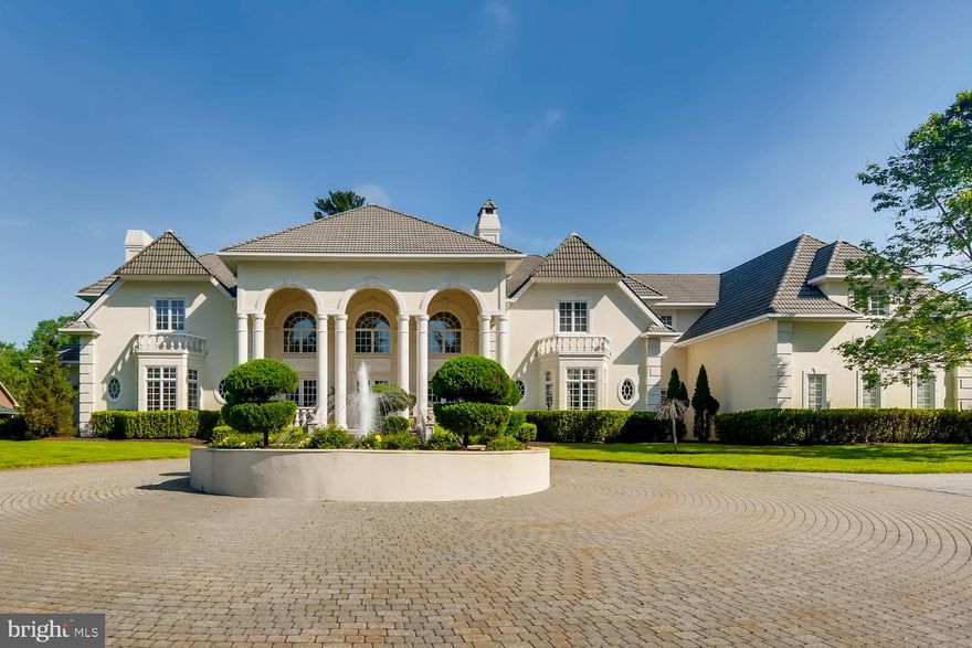 This Custom Villa Estate Displays Masterful classic design balanced with modern luxury nestled on over 9 acres. Enter through the private iron security gate and notice the 15 foot fountain - the centerpiece for the gorgeous circular driveway. An impressive two-story foyer with granite flooring greets you upon entering, leading you to the 23 foot high Living Room with floor-to-ceiling windows, elegant wainscoting, new herringbone wood floors, and custom fireplace -a room worthy of entertaining even the most refined guests.The huge gourmet kitchen with Wolf and Sub-Zero appliances, multiple islands and amazing high end cabinetry would make any chef envious, while the attached family room with full bar offers the perfect space for more casual entertaining. The dining room is something from a dream with a custom constellation-like ceiling mural and stunning furniture included in the sale, as well as a double sided fireplace which also serves the foyer.A giant domed sun-room looks out over the new full length bluestone terrace, the multi tiered courtyard and seductive heated pool / hot tub with fully equipped pool house.  The entire pool patio has just been replaced, along with a new grilling station with granite countertops and its own separate matching patio, just perfect for any sized gathering or family cookout.The light filled Master Suite, also located on the Main Level, contains a Spa- like Bathroom with two enormous vanities, Two Walk In Closets and A Sitting Room with Fireplace. Custom stained glass allows lots of light while maintaining privacy. A Grand and stately Cherry wood Library and Office with fireplace, bar, and brand new wood floors sits just steps away from the master bedroom.4 of the 5 large second-level bedrooms have full bathrooms, with one huge corner bedroom currently serving as a photography studio and lounge. You'll find Laundry service in four different areas - upstairs, in the master suite, in the huge mud room by the 4-car garage, and also the pool house, which has an additional two car garage underneath.The fully finished basement is equipped with a commercial-like gym with state of the art equipment and a rotating mountain climbing wall.  You'll also love the eight- plus person theatre, giant wet bar, and space for a dance floor, rec room or whatever your heart desires. The  barn  style building at one edge of the property contains a half basketball court and serves as the sports hub - it can also serve as storage for multiple cars or boats. The paved area in front of the barn can be used as a tennis court.There are many opulent homes on this incredibly desirable stretch of Brooklandville, but few as remarkable as 1716 Greenspring Valley Road.