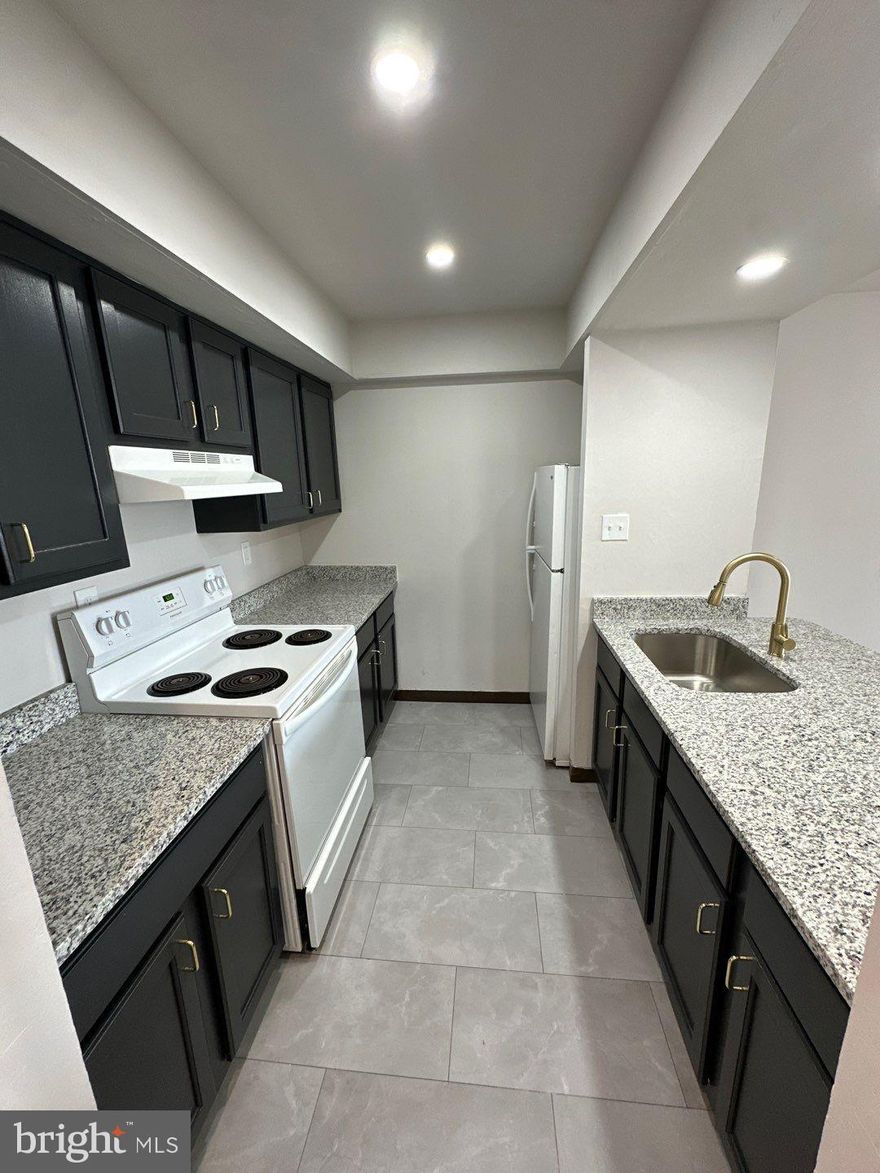 Tastefully updated, spacious , and bright - 2 bedroom, 2 full bath apartment awaits its new resident. Great location on Rhawn within easy walk to Winchester Park, or Frankford Avenue. Apartment has been redone to include solid surface flooring throughout. Kitchen has granite and large island great for dining, but there is also space for a formal dining table. Recessed lighting throughout. Laundry room on site. Owner pays cold and hot water, sewer, trash.