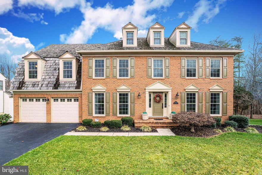 Stunning, pristine brick-front, center hall colonial shines from pride of ownership!  Owners have invested $100k+ on renovations & updates, to include all new windows & doors, carpeting, HVAC systems, water heater & more! Grand 2-story foyer greets you with hardwood flooring, gorgeous custom moldings & dramatic curved staircase.  Sunny light-filled & spacious living & dining rooms with beautiful crown moldings!  Elegant french doors open to separate office.  Expansive eat-in kitchen with large island, breakfast area, cooktop, granite counter tops, pantry, on-trend pendant lighting, stainless appliances, butler's pantry,  double wall ovens, work/desk station, and an amazing view from large kitchen window! Kitchen OPENS to spacious great room with soaring ceilings, floor-to-ceiling windows surrounding brick fireplace with mantle, and french doors lead you to expansive multi-level deck overlooking gorgeous views of creek & woods!  Upper level  offers large hallway with family room overlook, owner's suite, en suite bedroom, hall bath & 2 other generous-sized bedrooms withe nice-sized closets.  Prepare to be WOW'd with the owner's suite with vaulted ceiling, sitting room, walk-in closets, and a SPECTACULAR "spa-like" bath with free-standing tub, 2 vanities, over-sized tile shower with seamless glass door, tile flooring & large windows.  Expansive walk-out basement ready to finish -- TONS of space & conveniently plumbed for 4th full bath, egress windows ready for easy build-out of 5th bedroom, and sliding glass doors lead to back yard.  Mudroom/laundry room off garage. Dual zone heating & cooling. Irrigation system. You're home!