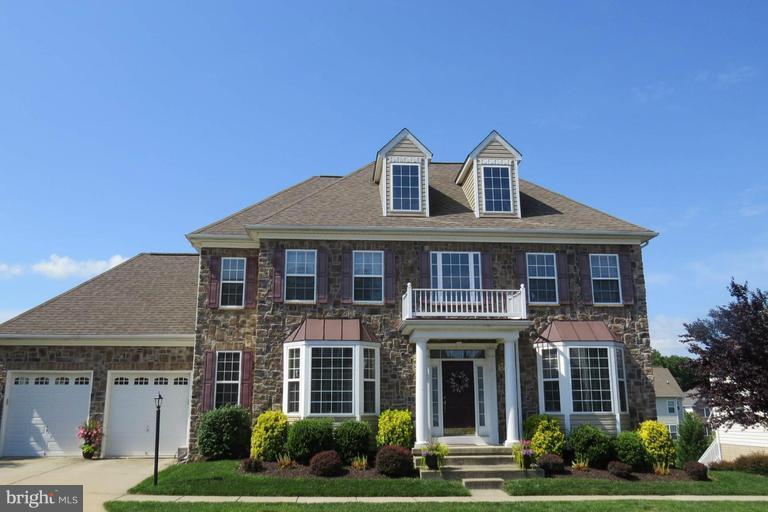 Stunning stone-front colonial featuring 5 br,3 full ba,2 car garage w/gourmet kitchen w/ granite countertops,42 inch cabinets,SS appliances, ceramic tile,gas cook top,double oven,island w/ breakfast bar seating & eat-in kitchen dining area.Main level bedroom, hardwood flrs,formal DR w/crown molding, gas FP. Master suite w/soaking tub, walking in closet, fully fenced yard. Desirable school district