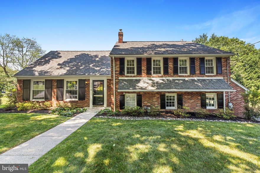 Wonderful opportunity to live on quiet street in Villanova in the award-winning Radnor School district and only minutes to shops, restaurants and schools. This classic brick colonial split-level home offers nearly 2900 Sq. Ft. of interior living and sits on a lush flat .50+ acre lot.   Oh and did we mention this home is move-in ready?   
From the front door, step inside to a center foyer with coat closet, gleaming hardwood floors and entry to a large and welcoming living room with replacement windows, recessed lighting and open floor plan to a spacious dining room with large rear window overlooking backyard and deck.  The Kitchen features granite countertops and updated appliances with a separate eating area and rear yard access to deck and covered patio area. 
Step down to a large and welcoming family room with brick fireplace and built-in bookshelves.   There is a mudroom and laundry room area, a full bathroom and inside access to an attached side load two car garage.  From the family room there is access to the covered patio with ceiling fan and rear yard.   The 2nd floor offers a primary suite with two closets and full bath. Two additional bedrooms and a hall bath complete the 2nd floor. There is another spacious fourth bedroom on the third level with closets, bookshelves, walk up attic access and loads of sunshine all year round.  Features include gas heat, replacement windows and doors and a maintenance free brick and siding exterior.  Schedule you’re showing today!