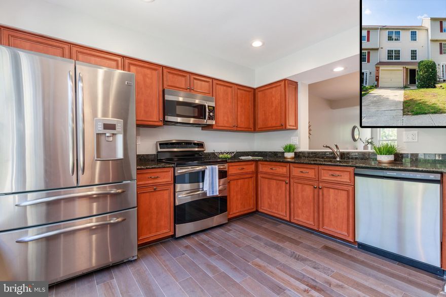 PICTURE PERFECT townhouse in the coveted Dorsey Hall community. Light- filled main level offers large living room area, dining area, half bath and gourmet eat-in kitchen with custom cabinetry, granite and stainless steel appliances.   Off the main living area is a sliding door open to a private deck perfect for entertaining.  The upper level contains a master suite with updated ensuite bathroom and  2 closets as well as two generously sized bedrooms and additional full bathroom. Walkout lower level features multi-function family room with access to the lush green rear yard. Attached garage and concrete driveway make parking a breeze. Fresh paint and all new flooring throughout make this home ready to move right into! House is vacant and easy to show so schedule a showing today! MULTIPLE OFFERS - HIGHEST AND BEST DUE BY SUNDAY 9/13 AT  5PM.