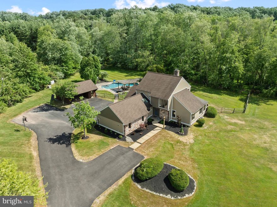 Properties like this one  don't come on the market often in New Hope-Solebury SD! This is your opportunity to own an 11 acre gated property in Solebury Twp. that offers the location, privacy and serenity you've been searching for, while allowing endless possibilities to expand. The home itself sits back off the road on nearly 3 acres of scenic open space- the remaining 8 acres are wooded for privacy, with man-made trails for your enjoyment.  As you pull up the winding driveway, you will immediately notice the brand new HardiPlank siding and exterior lights on the home (June 2024). Stepping inside, to your left you will walk past a first floor laundry room and half bath before entering the Primary bedroom complete with an en-suite bath. Go back down the hall to find the kitchen with bar seating that opens to the dining room. This home has an open airy floor plan with views from every room! Watch the most stunning sunsets through the windows in the living room and den or sit by the double-sided stone fireplace to relax as the leaves begin to change and snow falls outside. A sitting room with walls of sliding doors that lead to a patio for the pool area finishes off the main level. Upstairs boasts the 2 remaining bedrooms, each one with its own full bath. There is a two car attached garage along with an additional detached outbuilding that offers parking for two more cars and a room to use for storage. A completely updated concrete pool/spa with a lovely outdoor entertaining space is ready to welcome you! Many improvements/updates have been done (see list in documents). Home is in Act 319. Septic has been upgraded for a 5 bedroom home providing the ability to enlarge the home!  Easy access to Philadelphia, NYC and Princeton. Subdivision may be possible according to the township. **BUYER IS RESPONSIBLE TO DO THEIR OWN DUE DILIGENCE** See Improvements List in MLS documents for your convenience.