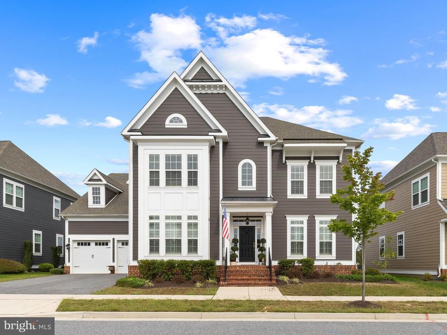 Live Authentically.  A new standard of modern living at Greenleigh at Crossroads—Baltimore’s premier “urban village” where lifestyle, design, and convenience converge. This exceptional, better-than-new Georgetown model has been elevated with thoughtful modifications, bespoke finishes, and custom details that set it apart.  Wide-plank wood floors flow throughout the home, recessed lighting, rough-ins for statement sconces and pendants, custom bamboo window shades and plantation shutters, built-ins and millwork.

A dramatic entry foyer makes a striking first impression, bridging formal entertaining spaces with the casual flow of everyday life. Designed with entertaining in mind, the butler’s pantry offers custom cabinetry, wet bar, quartz counters, beverage fridge, and ice machine, while seamlessly connecting the kitchen and dining room. The open-concept chef’s kitchen pairs crisp white cabinetry with roll-out and soft-close features, quartz counters, an oversized island, glass tile backsplash, and a professional-grade KitchenAid appliance suite—including a six-burner Wi-Fi enabled range with custom hood and pot filler faucet. A built-in Miele coffee station completes this indulgent space. The adjoining breakfast room opens to the rear yard, while a thoughtfully designed family entry foyer from the garage with quartz counters, cabinetry, storage closet and pantry keeps daily life beautifully organized. The light-filled great room, anchored by a gas fireplace with custom mantle creates a casually elegant gathering space.  Tucked off the entry foyer is a full bath and bedroom six, also perfect for quiet home office space.  

A sweeping waterfall staircase rises from the reception area to the second-floor landing. Double doors introduce the luxurious primary suite, a retreat that sprawls across the back of the home. A separate den adds versatility, while a swoon-worthy custom closet with boutique styling is complemented by a secondary walk-in. The spa-inspired bath with soothing tonal harlequin tile flooring showcases an oversized shower with waterfall faucet, hand wand and dual benches, soaking tub, hammered nickel sinks set in an expansive 8-foot quartz vanities, and designer mirrors with sconces.

Generously sized secondary bedrooms, including a front-facing ensuite with sitting area and walk-in closet with custom shelving. Bedrooms three and four share a stylish bath with granite vanity, tub/shower, and statement mirror. A laundry area is cleverly tucked behind double doors for convenience.  The third floor delivers flexibility for today’s lifestyle—wired for Wi-Fi and coax—making it ideal for a home office, creative studio, or a fifth bedroom with full ensuite bath and closet.

Outdoor living possibilities are endless, with HOA-approved plans ready and available to inspire the next owner. A rare oversized 2 car garage option with tandem parking for a third car, plus two driveway spaces and ample guest street parking.  Beyond the home, Greenleigh offers unmatched amenities: clubhouse, swimming pool with separate gated children’s pool, fitness center, conference space, outdoor patio and grilling areas, dog parks, playgrounds, and community greenspaces. Restaurants, retail, and everyday conveniences are a short walk away.  Minutes from I-95, the Beltway,  MARC train, Martin State airport for private flights, Gunpowder State Park, and marina options. Lawn and landscape maintenance are included, allowing you to simplify life and focus on what matters most. Every space here is curated to elevate both lifestyle and design—a sophisticated retreat in a vibrant, connected community. Cultivate your existence.  The art of uniting human and home.  *Sellers require pre-approval or proof of funds for showing approval.