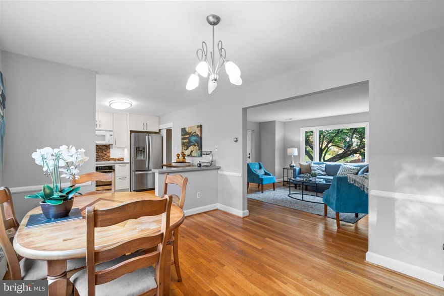 Welcome to 2306 Barbour Road, a thoughtfully renovated home offering over 2,200 finished square feet of living space across four finished levels on a quarter-acre lot in Falls Church! Outside, blue stone steps lead to the front entry and solid hardwood floors throughout the main level. In the living room, a picture window floods the room with natural light and a wood burning fireplace makes this the gathering place on chilly evenings. The dining room is open to the updated kitchen with 42” cabinets and a two doors provide access to the carport, screened in porch (with a new roof), and deck for seamless outdoor entertaining. Up one level, you’ll find two generously sized bedrooms and a full bath, while the first lower level boasts two additional bedrooms with full daylight windows and another full bath. The expansive fourth level features a large recreation room with a second fireplace, an office nook, pantry room, and laundry with walk-up access to the backyard. There is a floored attic for extra storage and mature trees that provide privacy in the backyard. Ideally located with easy access to Route 7, I-66, West Falls Church metro, Tysons Corner and the City of Falls Church. From here you can walk to the W&OD Trail and enjoy great nearby dining and shopping options at Birch & Broad, Idylwood Plaza, and the new West Falls and Founders Row developments. Welcome home!