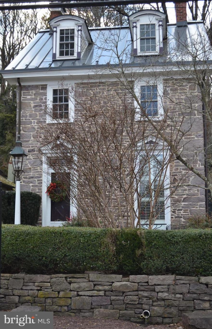 Don't miss the chance to call this home. Drive north along the river, notice the change in colors as captured by many renowned Bucks County artists, the reflection from the river, a sense of serenity as you arrive  in much sought after historic Lumberville with architecture resembling  an English, or European style village.  It's possible you might spot a celebrity. The beauty of this stately, stone colonial circa 1825 sits high above the river, now Delaware River views, , needs no flood insurance. 4 bdrm, 2.5 bath, near 2,200 Sq ft, 3 story gem has parking, strong presence ,walk around the town perfect for full time or weekenders.  Observe the rear patio stone walls, boxwood, perennial gardens, private large back yard,  3 stone patios for outside dining, old stone workshop ruins, panoramic view of deck off primary bd rm, garden shed, stone well house.Renowned NH Solebury School District.   As you are welcomed, passing through the thick panelled wooden front door with old knocker, gas stove fireplace, multiple bookshelves plantation shutters casting lovely lighting. Key selling point are wooden floors, stone wood burning fireplace,crown molding, millwork, deep window sills,replaced windows. The kitchen has Wolfe gas stove top, deep Nantucket stainless sink, granite countertop, radiant heated floors,stainless steel refrigerator, new dishwasher, windows for watching the garden, stone well, birds, trees. Old door hardware & abundance of windows give a sense of the deep history of the house. Primary bedroom is an addition with  French doors to deck for  tea/coffee or afternoon refreshment.  Double sinks, granite countertops in Bathroom, stackable washer/dryer in primary bathroom. Lots of windows and high ceiling in 3rd floor bedroom that share a hall pedestal sink, bathroom with front bedroom that has river views,stone interior wall. Pristine basement with impressive floor joists, new French drain. Metal standing seam roof, cooper trim down pouts, gas powered backup generator.  Redesigned Carport, spacious parking, easy to set up "car charging station". Enjoy the life style of walking, meeting others around village by starting with latte and breakfast at Lumberville General store, walk across the Delaware River Bridge to Bulls Island Park & boat launch. Dine on the deck at Black Bass Inn restaurant,  Bike or walk  Fleecydale Rd into village of Carversville. New Renovated Kolbe Antique Store,Dog & Deer Tavern, Stockton  Inn, Farmer's Market, Prallsville Mill Art/photo studios, art galleries, Bucks County Playhouse, New Hope Winery, live music, restaurants, horse farms, tennis/golf clubs.  60 mins to Philly, 75 mins NYC. Beach ? Ready for a change?  Make an offer. Enjoy your new home for the Holidays.