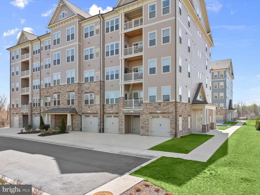 Welcome to The Woodlands in Urbana, a premier 55+ community where elegance meets convenience. This stunning condo offers wonderful views, an attached garage, and an open floor plan filled with natural light, creating a warm and inviting ambiance. Step into the welcoming foyer, which features a walk-in pantry and seamlessly flows into the spacious living and dining areas. From here, enjoy direct access to a private balcony perfect for relaxing and taking in the scenic surroundings. The eat-in kitchen is a chef’s delight, boasting sleek stainless steel appliances, granite countertops, decorative backsplash, breakfast bar, and a center island for effortless entertaining. The primary bedroom serves as a peaceful retreat, complete with a walk-in closet, an additional closet, and an en-suite bath featuring dual vanities and a glass-enclosed shower. A second spacious bedroom with an integrated office area, a full bath, and a convenient laundry room complete this beautifully designed home. Located just steps from Urbana’s thriving Market District, The Woodlands is an intimate, amenity-rich community designed for an active and vibrant lifestyle. Residents enjoy a private clubhouse with a fitness center, game room, yoga studio, and club room, as well as an open-air pavilion, outdoor pool, putting green, pickleball and bocce courts, a potting shed and garden, multiple outdoor fireplace settings, walking trails, a tot lot, and a dog park.