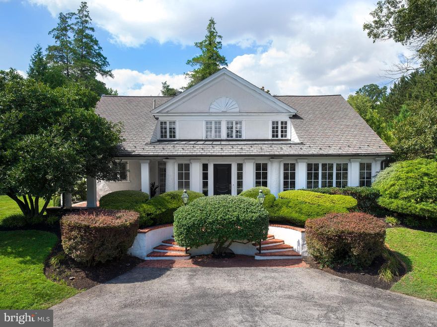 Set well back from the road, enter past mature bushes and trees down a driveway that opens to majestic estate-like grounds. This completely renovated home offers privacy and serenity in Villanova's estate area near Cedar Lane and Appleford. The property embodies exquisite style and design, featuring high-end finishes that align with the preferences of today’s buyers. Every detail was selected to create a blend of modern luxury and timeless charm. From the elegant marble countertops and custom cabinetry in the kitchen to new hardwood flooring throughout, the home exudes sophistication while maintaining a warm and inviting atmosphere. The extensive updates have transformed this property into a move-in-ready masterpiece, offering the perfect fusion of modern functionality and classic appeal. The estate-like grounds provide an idyllic retreat, offering a wealth of outdoor amenities, including a saltwater pool with newer hardscaping, an outdoor shower, a basketball court, a treehouse, multiple patios, and a pergola, —perfect for relaxation and entertainment. The interior of the home is equally impressive, starting with a foyer featuring marble floors and French doors leading to a porch with a brick floor. Elegant details such as custom molding in the living room, dining room, and foyer, original beams on the living room ceiling, and a decorative plaster fireplace with a herringbone brick hearth add historical charm to the modernized space. The custom Chippendale staircase railing and new hardwood floors, which continue throughout the first floor and primary bedroom, further enhance the home's aesthetic. At the heart of the home is the stunning chef’s kitchen, featuring Calcutta gold marble countertops and backsplash, painted inset shaker cabinets, 2 large islands, and a coffee bar. High-end appliances include a Viking stove, KitchenAid double ovens with convection, a Subzero refrigerator, and a Bosch dishwasher. The kitchen’s luxurious fixtures and lighting from Restoration Hardware and Rohl elevate the space, while large pantry cabinets provide ample storage. The seamless flow from the kitchen to the dining room and beyond offers convenience. The family room is a true showstopper, with 12-foot ceilings, custom built-in bookcases, thick crown moldings, and a wood-burning fireplace. This room features 2 sets of French doors leading to the pool area and a 3rd set that opens to the yard. The sunroom, with original brick herringbone flooring, built-ins, and French doors leading to stone steps and the side yard, is another highlight. The powder room has been beautifully updated with Serena & Lily wallpaper, a herringbone marble floor, and new fixtures, while the mudroom, complete with built-in cubbies, provides access to the 3-car garage and driveway. Upstairs, the primary bedroom is a luxurious retreat with a barrel ceiling, a Palladian window and 4 spacious closets. The primary bathroom includes marble floors, a jacuzzi tub, and shower, creating a spa-like experience. The additional bedrooms are generously sized, featuring newer carpets, large closets, and charming details like deep window sills. One bedroom includes a princess bathroom with a tub, while another serves as a home office. The upstairs also features a laundry area, 2 hall linen closets, and a skylight that fills the space with natural light. Additional updates include a new roof (2017), new HVAC and furnace systems, a tankless water heater, a new oil tank, and modernized pool equipment, including a new motor, salt cell, and control board for the saltwater pool. The home also boasts new interior paint throughout the main level and upstairs, new light fixtures, and additional trim in the formal living and family rooms, stairway, foyer, and powder room. This home seamlessly blends historical charm with modern updates to provide a one-of-a-kind living experience.