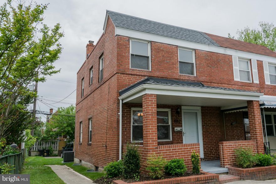 End of Group, all brick townhouse, with 2 car rear parking pad, all new interior, hardwood floors, granite kitchen counter tops, S/S appliances, finished lower level with bath/shower stall. Landscaped yard, deck off kitchen. Ready move-in condition. E-Z to See.