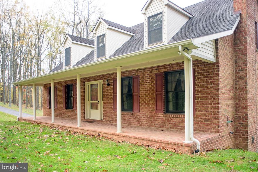 Peaceful and serene 2.5-acre setting—truly a rare find! Custom built, brick home!  Surrounded by nature and offering beautiful mountain views, this custom-built brick Cape Cod has been lovingly maintained by its original owner. Relax on the charming covered front porch and take in the tranquility of your surroundings. Inside, you'll find a spacious eat-in kitchen with stainless steel appliances, a warm and inviting living room with a wood stove, and a convenient main-level primary bedroom with full bath. The upper level features two generously sized bedrooms, a full bathroom, and a large family room—perfect as a second living space, play area, or home office. The lower level includes a dedicated laundry room and a hobby/workroom with plenty of flexibility to suit your needs. Enjoy the convenience of the oversized 28x25 side-loading garage, complete with a side door leading to the yard—no need to get wet carrying in groceries. This property offers the perfect blend of privacy and outdoor adventure. Walk to Washington Monument State Park, ideal for hikers, nature lovers, or those seeking a peaceful weekend retreat. All this, just minutes from Frederick and the quaint town of Boonsboro. Don't miss this rare opportunity!