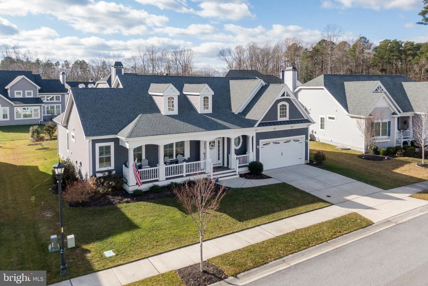 This very impressive classic Traditional/Craftsman home is located in the Nantucket section of the well-established Coastal Club private community in Lewes, Delaware. Built by Schell Brothers, this Mayberry model home features a spacious two-story layout with four bedrooms and three full bathrooms. The property is in mint condition offering a bright open floor plan that showcases beautiful engineered hardwood flooring and Cathedral ceilings creating an inviting atmosphere throughout. The home boasts a custom-built dry bar with lighted glass front cabinetry and a wine rack making it perfect for entertaining guests. The upscale gourmet kitchen is equally impressive featuring glass cabinetry, quartz countertops and a  walk-in pantry for ample storage. The kitchen opens to the great room and sunroom filling the living spaces with natural sunlight and providing scenic views of the landscaped back yard. Residents can enjoy a relaxing rear sundeck equipped with a gas line for grilling and ideal for outdoor gatherings. Additional conveniences include a laundry room with a utility sink and a second floor walk-in attic providing excellent storage options. This tasteful home presents great value thanks to its strong rental potential and exceptional amenities and a prime location. The property is situated within minutes of the Beaches, the Restaurants, Shopping , the Cape Henlopen State Park and the Cape-May Lewes Ferry making it an outstanding choice for both a comfortable living and an investment.