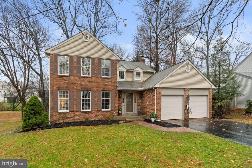 Stately brick-front Colonial offering 4 bedrooms, 3.5 bathrooms, and 3,312 square feet in sought-after Burleigh Manor. Hardwood floors span the traditional layout, beginning in the impressive 2-story foyer enhanced with wainscoting and chair rail molding. The foyer opens to the left into the formal living room and continues seamlessly into the elegant formal dining room. The beautifully appointed eat-in kitchen features granite countertops, an island, stainless steel appliances, a breakfast bar, an arabesque tile backsplash, and a cozy breakfast nook illuminated by pendant lighting. Just off the breakfast area is a welcoming family room showcasing a white-washed brick wood-burning fireplace and access to the deck. This level also includes a well-appointed laundry room, a versatile study/sunroom, and a convenient powder room. Hardwood floors extend into the upper level, where you’ll find four spacious bedrooms, including the serene primary suite with two walk-in closets and a gorgeous en-suite bathroom with a dual-sink vanity. A second full bathroom with double sinks serves the additional, generously sized bedrooms. The lower level offers a large open recreation room with two closets and a full bathroom, a versatile bonus room ideal for guests or a home office, and a dedicated storage room. Outdoor living includes a spacious deck overlooking the fenced backyard with a play area—perfect for relaxation or recreation. An attached 2-car garage, along with a convenient EV charger, completes this beautifully maintained home.