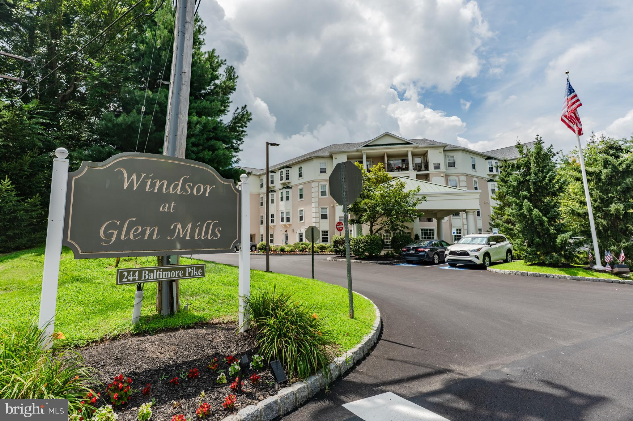 Discover unparalleled elegance in this stunning end-unit condo in the sought-after Windsor at Glen Mills, a premier 55+ community designed for effortless living. Spanning 1,187 sq ft, this larger-than-most unit is in pristine condition, offering 2 spacious bedrooms, 2 luxurious bathrooms, and exceptional features tailored for comfort and convenience. Enter to find hardwood flooring in the hallways, plush carpet in the bedrooms and living areas, and ceramic tile in both bathrooms. The master suite is a serene haven, featuring a private bathroom with a walk-in shower, dual closets (including a walk-in), high ceilings, a ceiling fan, and an expansive bay window that bathes the room in natural light. The second bedroom is generously sized, with a large closet and high ceilings, perfect for guests or a home office. This end-unit stands out with rare amenities: a private deeded parking spot in the indoor garage, located next to the elevator, which opens steps from your door for ultimate accessibility. A private storage unit adjacent to the parking spot adds extra convenience. Relax or entertain on your large balcony, ideal for enjoying morning coffee or evening breezes. The home boasts modern upgrades, including a newer HVAC system, water heater, and select windows, ensuring energy efficiency and peace of mind. High ceilings throughout enhance the open, airy ambiance. At Windsor at Glen Mills, enjoy a maintenance-free lifestyle with access to an exceptional clubhouse featuring a bar/cafeteria, library, mailroom/package room, billiard room, TV room, gaming room, and an office with computers. Stay active with the accessible outdoor pool, perfect for warm days. This vibrant 55+ community takes care of everything, so you can focus on living your best life. Don’t miss this rare opportunity to own a spacious, move-in-ready end-unit condo in Glen Mills’ premier 55+ community. With its prime location, modern upgrades, and unmatched amenities, this home defines luxury and convenience. Schedule your tour today!