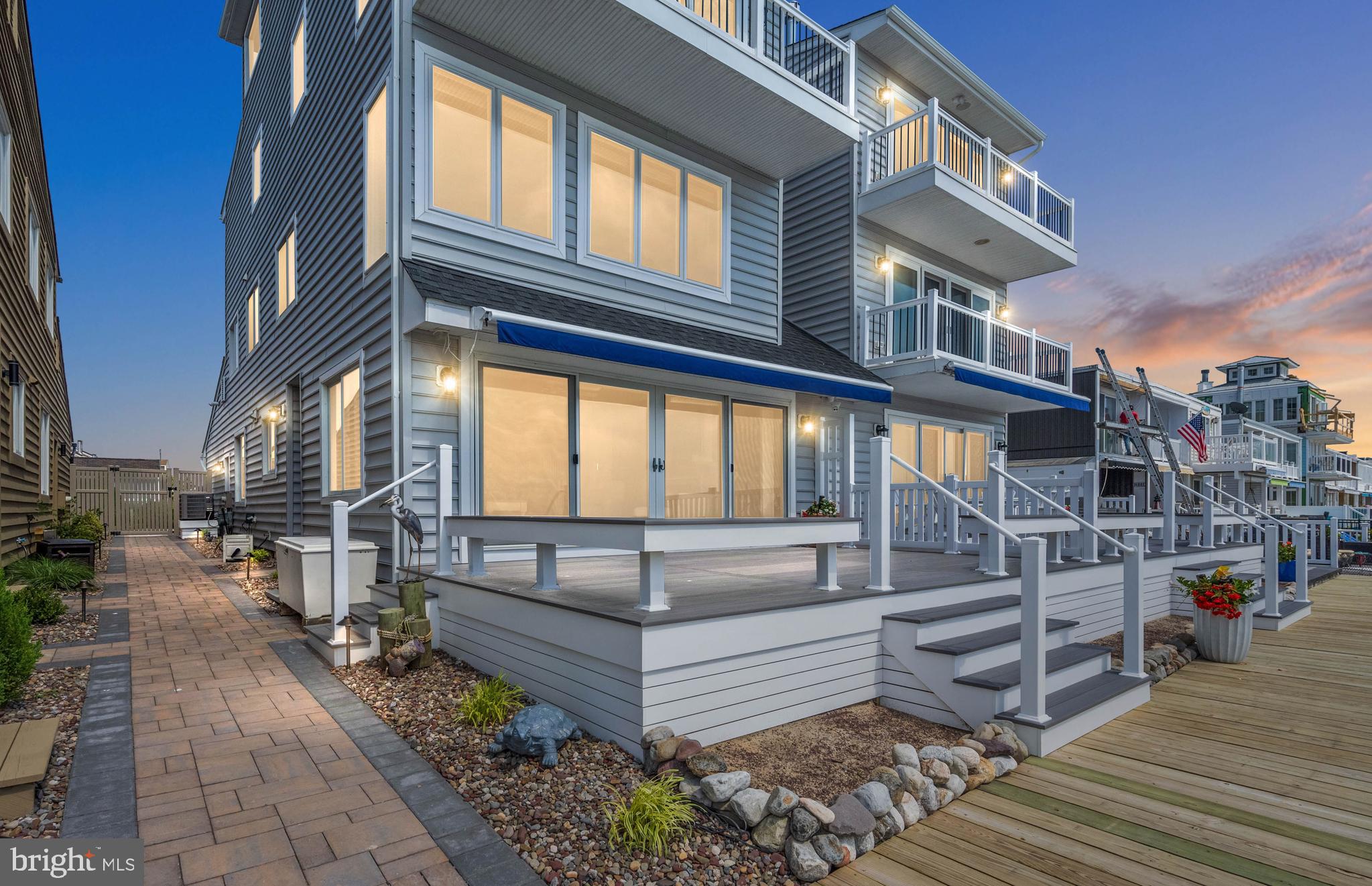 Welcome to wonderful Bayfront Living in Ocean City. This residence is a unique and rare find that offers both a serene retreat and a boater’s dream. This home features 3 Bedrooms and 4 Full Baths, with many recent updates. As you step inside, you see the sweeping views of the bay.
Large doors and windows allow natural light to flood in. New siding, roof and balcony. Spacious outdoor living with a new deck and retractable awning. New bulkhead with extended 45 ft long pier, boat lift and jet ski lift. Rare large 2 car garage with cabinets for storage, extra refrigerator and an attic. Also, new garage door and epoxy coated garage flooring. Newly resurfaced driveway with the convenience of 2 additional parking spaces. Gas fireplace with remote in Living Room. TV Home entertainment system.
Smart home with control of doors, lights and alarm system. No HOA. Seize the opportunity to see an exquisite sunset every night and claim your piece of the Ocean City life!
