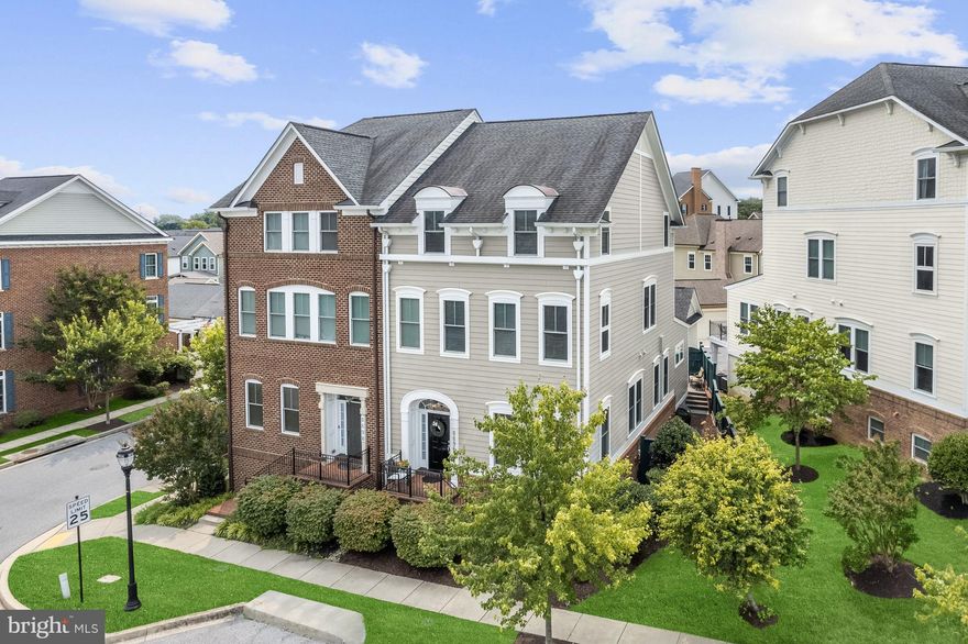 Huge, end of group Mitchell and Best model townhome located in Fulton’s amenity rich Maple Lawn community. This impeccably maintained home boasts over 4,500 sq. ft. of luxurious living space with a bright and airy, open floor plan with fresh paint and high-end upgrades throughout that include high baseboards, 3-piece accent crown molding, and built-in speakers.  Gorgeous hardwoods, wide archways, and a lighted wall niche are highlighted in the living and dining rooms creating the perfect ambiance for intimate gatherings.  You’ll love entertaining in the chef’s kitchen that features an oversized island with a sink and breakfast bar, sleek granite countertops, 42 in. rich wood cabinetry, and stainless appliances that include a Wolf 6-burner gas range, and a breakfast room.  A cozy gas burning fireplace flanked by custom bookcases becomes the focal point of the off-kitchen family room that provides access to the patio and garage.  Ascend the staircase to the primary bedroom suite that includes a sitting room, 2 walk-in closets with organization systems, and an en suite luxury bathroom with a soaking tub, frameless shower with seating, 3 body sprays and 2 shower heads, and dual granite vanities. The laundry room is conveniently located on this level and the top level includes a loft, and 2 sizable bedrooms each with its own full bathroom and walk-in closet.   The lower level provides a recreation room, bedroom, a full bath, and abundant storage space. Enjoy outdoor living on the patio in the privacy fenced backyard and the vast variety of community amenities that include a swimming pool, clubhouse, fitness center, tot lots, and more!