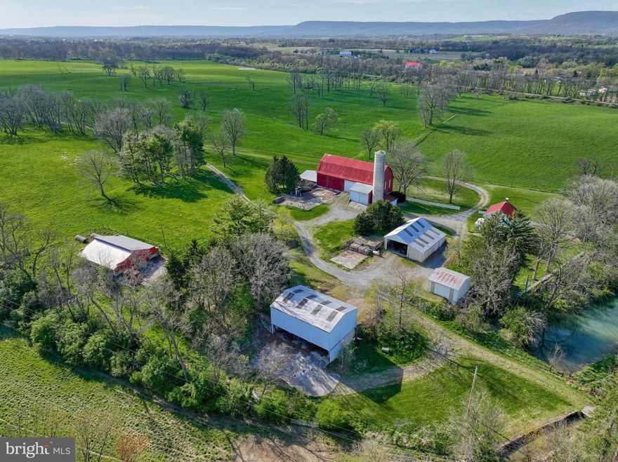 Welcome to a piece of history nestled in the picturesque landscapes of Carlisle, PA! This sprawling farm offers an unparalleled opportunity to own a slice of rural charm with modern conveniences. The property is not under any land preservations or conservation easements providing an opportunity for you the opportunity to utilize that opportunity if needed. See agent remarks for an additional rebate opportunities regarding the property as well. Boasting almost 2 miles of meticulously maintained electric fencing, this property is primed for livestock management. At the heart of the estate sits a charming 3-bedroom, 1.5-bathroom farmhouse, exuding timeless appeal. With its cozy interior and classic design, it's the perfect place to call home. For the discerning farmer or hobbyist, there are four barns and two garages/shops, providing ample space for equipment storage, workshops, or any other agricultural pursuits. Additionally, two vertical cement silos stand tall, ready to support your farming operation. The land itself is a testament to its agricultural potential. Blessed with all limestone Hagerstown silt loam soils, currently in pasture, it presents a golden opportunity for over 140 acres of row crop cultivation. The property has been thoughtfully maintained, ensuring its productivity and value for generations to come. Beyond its agricultural prowess, this property holds immense investment potential. Surrounding zoning is predominantly R-1 or R-2, with industrial zoning next door, opening avenues for future development or rezoning opportunities for those willing to take on the challenge and opportunity. Steeped in history, this farm stands as a landmark in the Carlisle area, proudly holding the title of the 3rd largest remaining farm in West Pennsboro Township. Whether you're seeking a serene retreat, a thriving agricultural venture, or a strategic investment opportunity, this property offers it all. Don't miss your chance to own a piece of Carlisle's rich heritage and secure your stake in its promising future. Schedule a viewing today and let this historic farm capture your imagination. Not much can be seen with a drive-by as the property offers a very private entrance and sits back off the roadway. Seller is requesting showings by appointment only with pre-approvals or proof of funds. Please respect the seller's request, no entrance without listing agent and scheduled appointment.