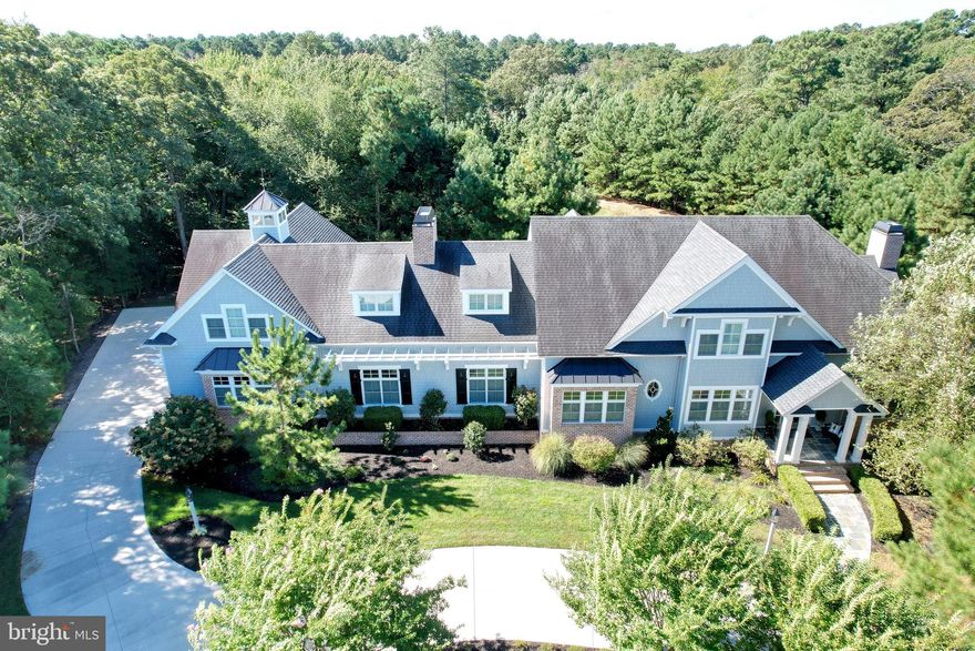 A coastal Nantucket Home that captures a resort style living with serenity and elegance on a large private lot with natural landscaping of the Henlopen State Park!  Open the door to this Nantucket home of wonderful customs amenities.  From natural hard wood floors to a great room with architectural exposed beams.  Beautiful built-ins, floor to ceiling fireplace for warm entertaining. Home features a gourmet stainless steel kitchen with custom design trim throughout the home and plantation shutters even in the garage!  An addition of a separate private suite with kitchen private bath and living room make this home exceptional. Outside you will find a full outdoor kitchen area with a hot tub, a pool and a glass gas fire pit! A  Coastal Nantucket home of incredible opportunity to make part of your life where memories can be created for all!