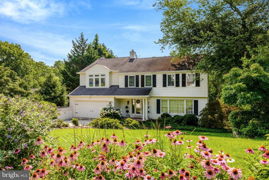 This brick Colonial offers 3 levels, a 2-car attached garage, and sits on a 0.4-acre lot. Set along a peaceful, tree-lined, non-thru street, the home has been lovingly maintained and updated with custom craftsmanship and elegant detailing. The neighborhood is known for its prime location just moments from Chain Bridge, GW Parkway, and Tysons Corner, and is in the McLean High School district. 

A brick walkway leads past architect-designed, master gardener-maintained landscaping to a brick portico highlighting an exquisite glass front door with sidelights. Opportunities for nature abound just minutes from Pimmit Run Stream Valley Park, Bryan Branch Park, Linway Terrace Park, and Highlands Swim and Tennis Club. 

A custom wood and beveled glass door welcomes you into the foyer. The main level features formal living and dining rooms with bay and bow windows, ideal for entertaining. The updated gourmet kitchen includes a large center island, custom cabinetry, and granite countertops, and opens to a breakfast area and casual living space with a gas-insert fireplace. A half bath and access to the 2-car garage complete this level. An oversized, architect-designed multi-level deck with a sunken hot tub (as-is) extends the living space outdoors. French doors from the breakfast area offer serene views of Bryan Branch Creek. 

The upper level includes a spacious primary suite with a walk-in closet. The marble-clad primary bath has been renovated with a double vanity, grab bars, walk-in shower, Toto ADA toilet, and custom cabinetry. Two additional bedrooms include one with built-ins for a home office. A hall bath features marble finishes, grab bar, ADA toilet, and custom cabinetry. Skylights above the oak staircase and in the bath provide natural light. A standout feature is the expansive great room or optional bedroom (approximately 600 sq ft) with tray and cathedral ceilings, built-ins with marble counters, hardwood floors, ceiling fans, dentil molding, and a beveled glass entry door. Extensive windows provide natural light and views, along with a built-in 82" TV (as-is) and surround sound system (as-is)

The lower level, accessed by an oak staircase with beveled glass door, includes a recreation room, bonus room for office or exercise, and a private guest suite with full bath, custom cabinetry, and walkout access to the patio. A utility room includes a Whirlpool washer and dryer, Bosch refrigerator/freezer, and ample storage. 

Outside, the fully fenced yard features a multi-level Trex deck with wide steps leading to a lower patio. The grounds are heavily treed with professionally landscaped tiers and pathways. Hardscaping includes stone wall terracing, stairs between levels, tree boxes, two greenhouses, an eight-zone irrigation system, outdoor lighting, and French drains. The greenhouses include gas heat, drip irrigation, thermostat-controlled vents, and lighting. 

Landscaping features specimen Japanese maples, Canadian hemlocks, kousa dogwoods, traditional dogwoods, and mature hardwoods including oak, maple, and elm. There are over 200 azaleas, hydrangeas, butterfly bushes, hostas, peonies, hibiscus, and perennial ground covers. A pollinator garden along the street includes coneflower, black-eyed Susan, bee balm, and ornamental grasses. 

Additional features include a two-car garage, multi-level storage, three-zone HVAC, security cameras, motion lighting, alarm system, enhanced cell and internet connectivity, hardwood floors, detailed molding, raised panel doors, and a floored attic with lighting and fan.