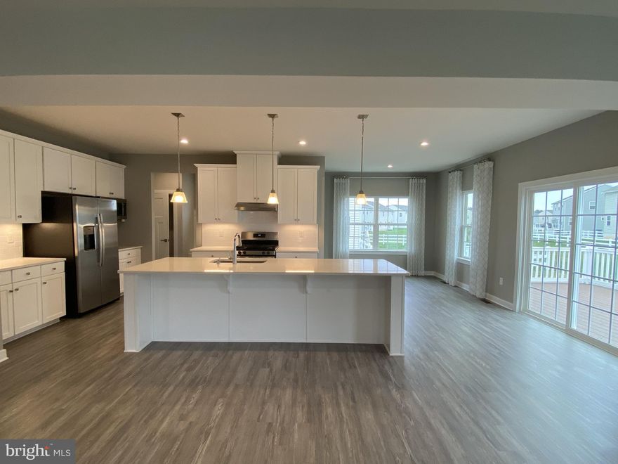 WELCOME to 712 Wallasey Dr,  the HUGE previously SENECA MODEL HOME by Ryan Homes. It is located in the sought out Appoquinimink School District, conveniently located off of 301 in the popular Preserve at Deep Creek community. Be the PROUD OWNER  to enjoy this model home with many upgrades at a DEAL PRICE. This Seneca model offers 4450 square feet of living space with three gorgeous levels, boasting a finished basement with a full bathroom on a great lot. As you drive to the house, you are greeted with a beautiful upgraded front elevation, lovely landscaping, and a full size porch. As you enter the foyer, you will find a spacious study/office on your right and a  powder room.  As you continue your tour, you'll find a gorgeous dining room and then the home opens up to a big open family entertainment space –  a warm living room, an expansive kitchen with a huge island, and beautiful eat-in kitchen area. The entire first level has upgraded LVP flooring. You will love the white on white modern kitchen featuring quartz countertops, plentiful 42” crown cabinetry, updated hardware, new light fixtures, stainless appliances, gas cooking, vented out hood, a large island, an eat-in dining area, and a walk-in pantry. From the kitchen, you can walk out to a large, accessible, no maintenance deck and leveled lot, perfect for entertaining and for outdoor gatherings. The huge family room has a gas fireplace to keep you warm and cozy in all seasons. By the side of the family room, you'll find a convenient  garage entrance which has an arrival center for all your accessories. From the living room, take the stairs to the second level where you'll find the enormous primary bedroom with a luxurious en-suite, featuring a large tile shower and two walk-in closets. You will have plenty of room for your family with three additional bedrooms, two of which share a Jack and Jill bath and a third, potentially a guest bedroom, that offers an en-suite bath. All bedrooms have walk-in closets, all bathrooms have easily maintained and aesthetically pleasing tiled floors. There is also a spacious center loft in this level for upper level entertainment. Upper level laundry completes the tour of second level. The finished lower level has three different entertaining areas to enjoy different activities.  You can easily convert a section into 5th bedroom. This gorgeous basement also has a full bath with finishes similar to the stylish bathrooms upstairs. There is a good size unfinished section in the basement for all your storage needs. All three levels have ample recess lighting and plenty windows to keep your home bright yet cozy. Other special features unique to this house are side entrance door for the garage, irrigation system for your lawn. Carrier HVAC system with two zone thermostat and tankless water heater are features that are done with  functional convenience in mind. Schedule your tour today. House comes with no furniture. Pictures give idea of the size and furniture option visualization. Any questions contact listing agent. One of the owners is DE licensed real estate agent and listing agent.